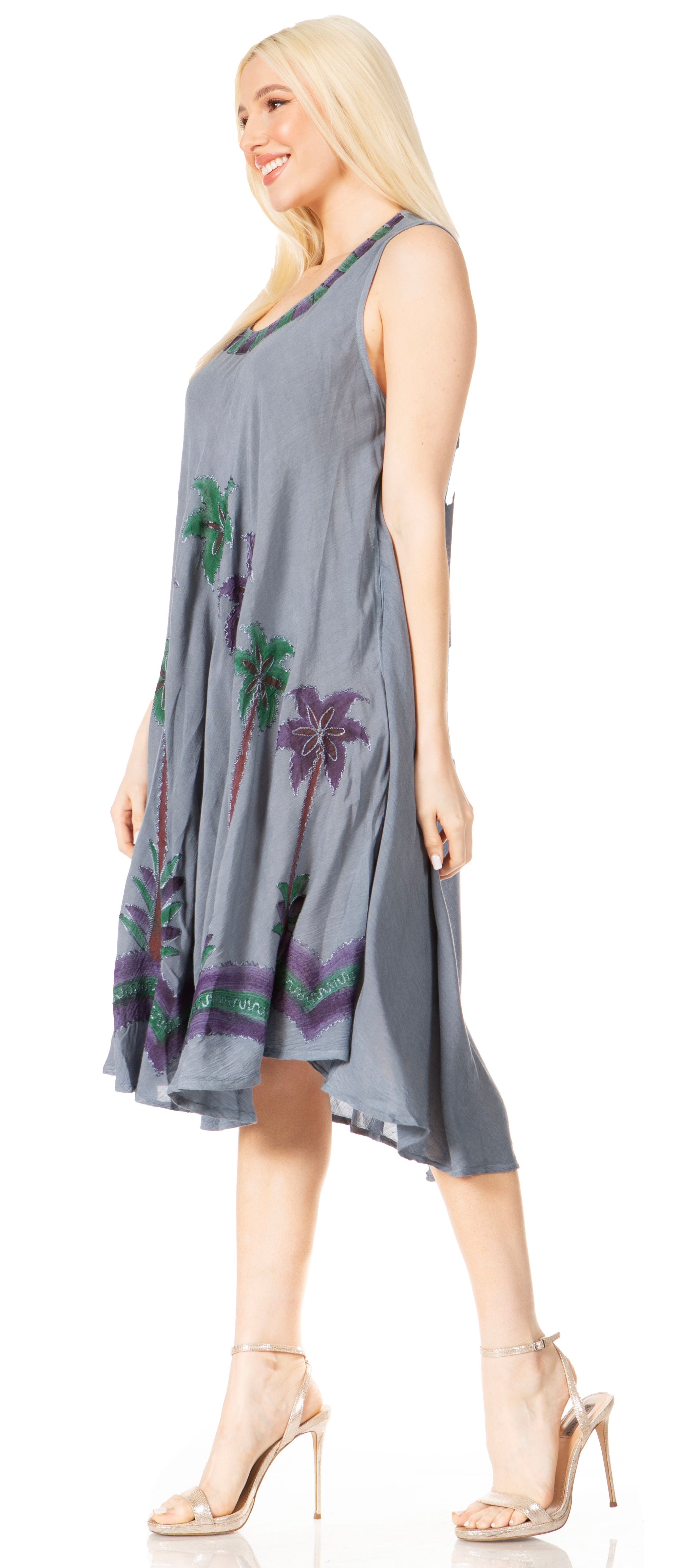 Woman wearing a gray dress with floral patterns on a white background