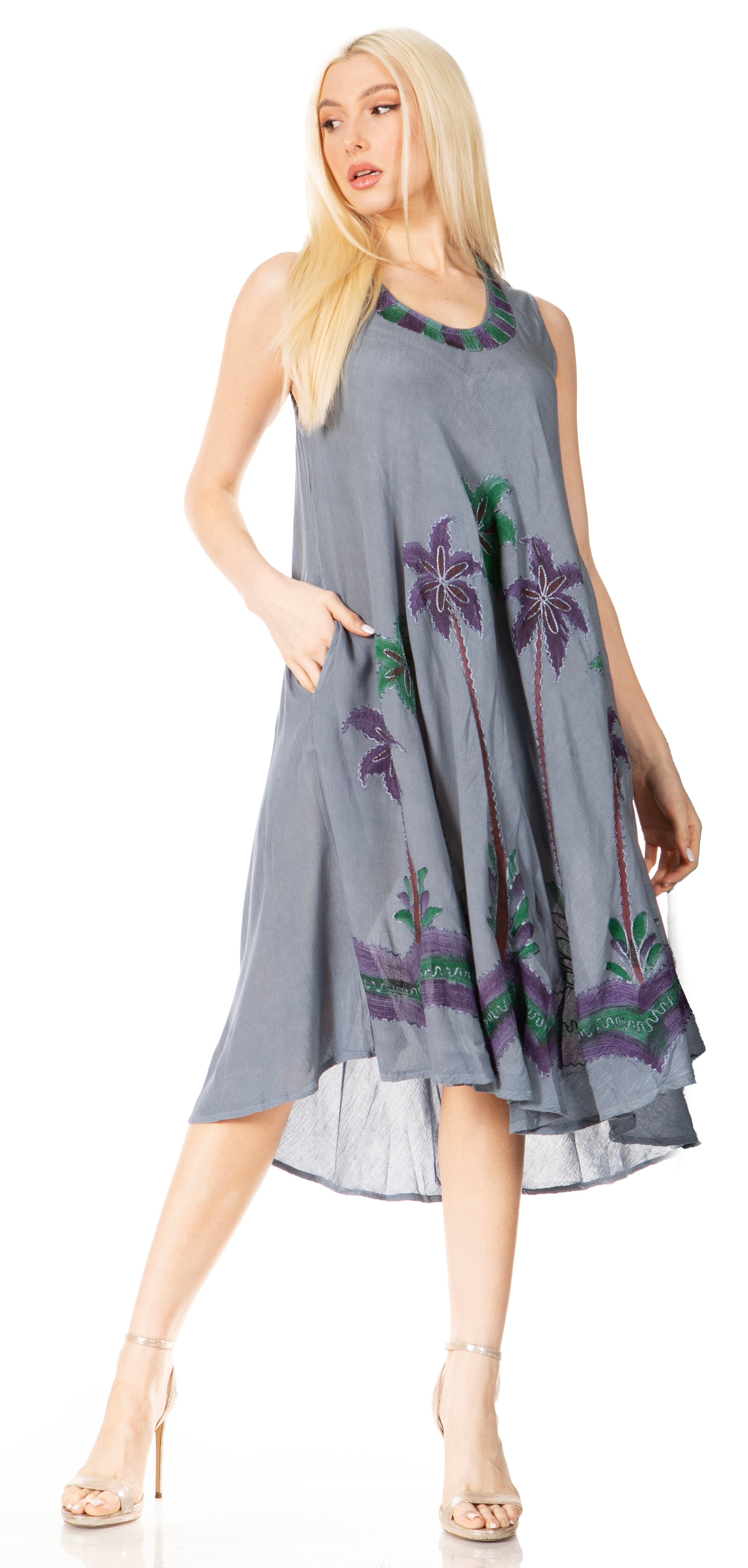 Woman wearing a gray dress with floral patterns on a white background