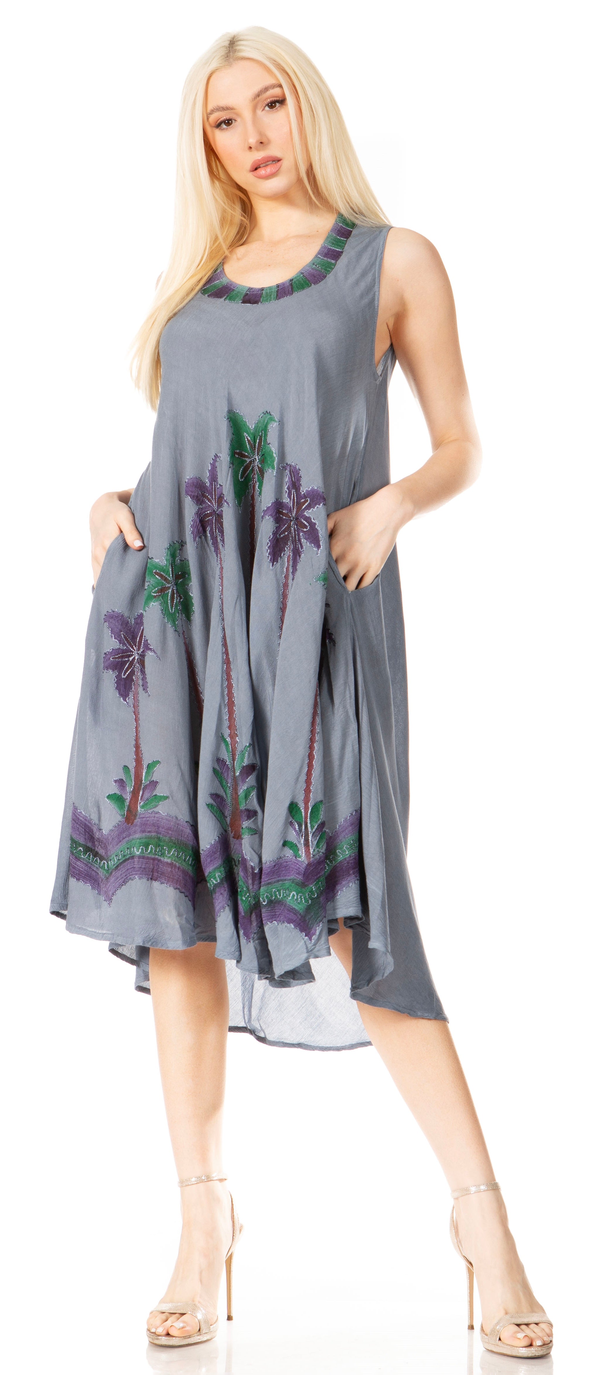 Woman wearing a gray dress with floral patterns on a white background
