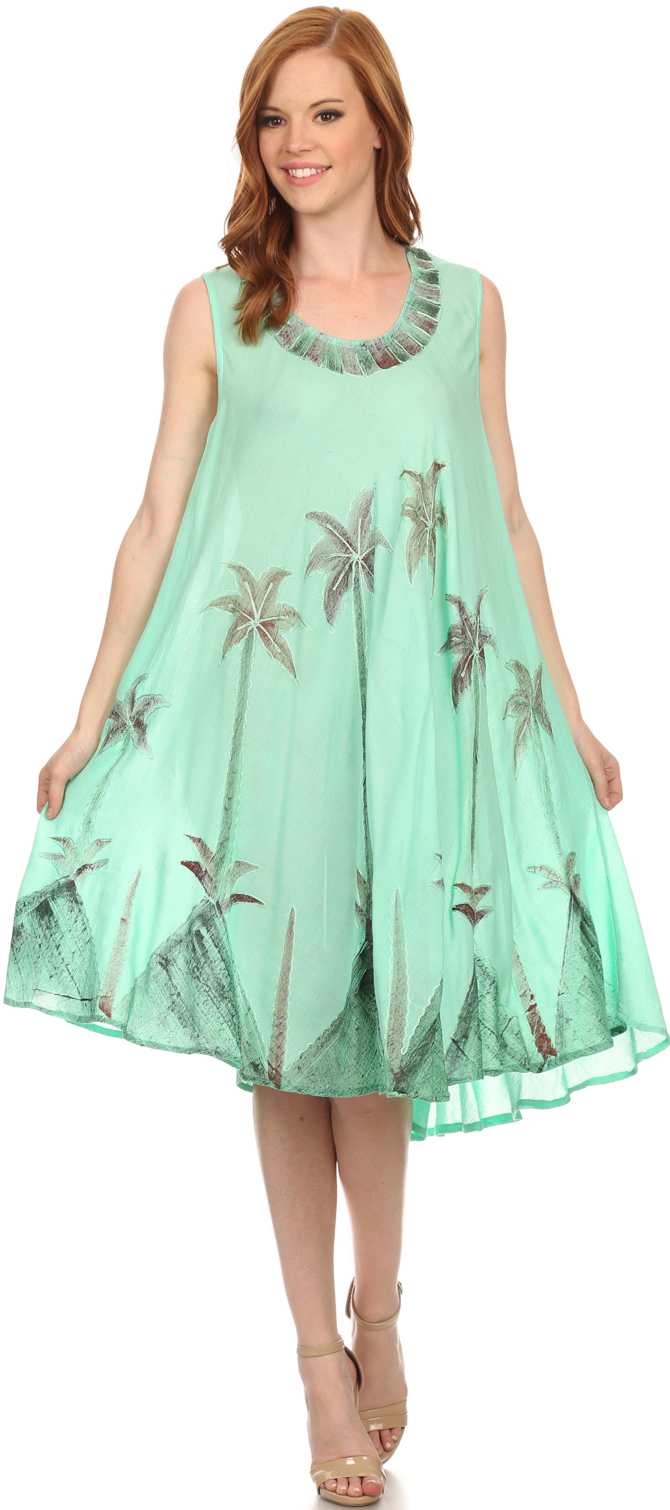 Woman wearing a light green dress with floral patterns on a white background
