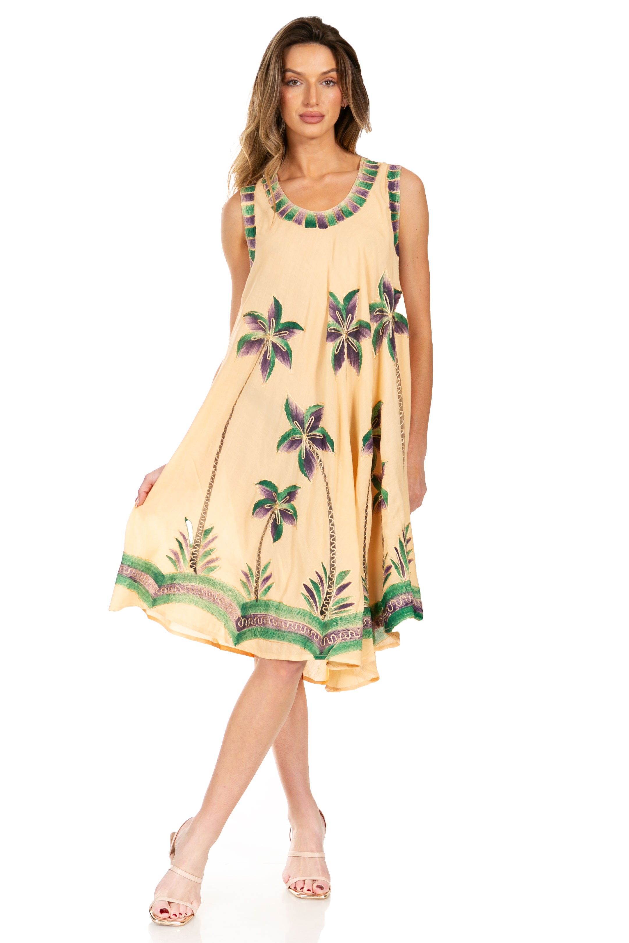 Woman wearing a yellow dress with floral patterns on a white background