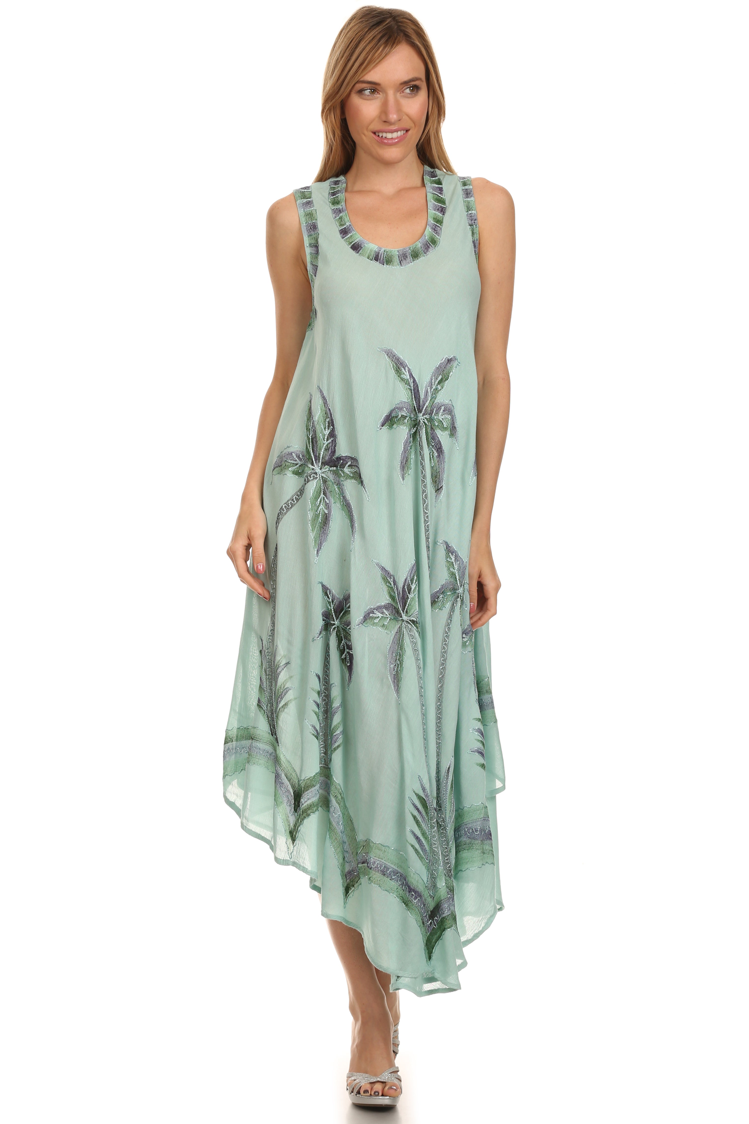 Woman wearing a sleeveless dress with palm tree pattern on a white background