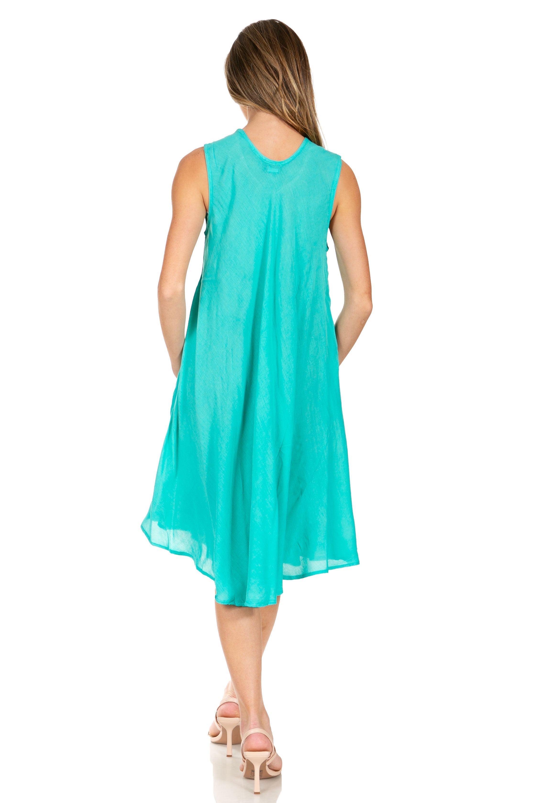 Woman wearing a turquoise dress on a white background