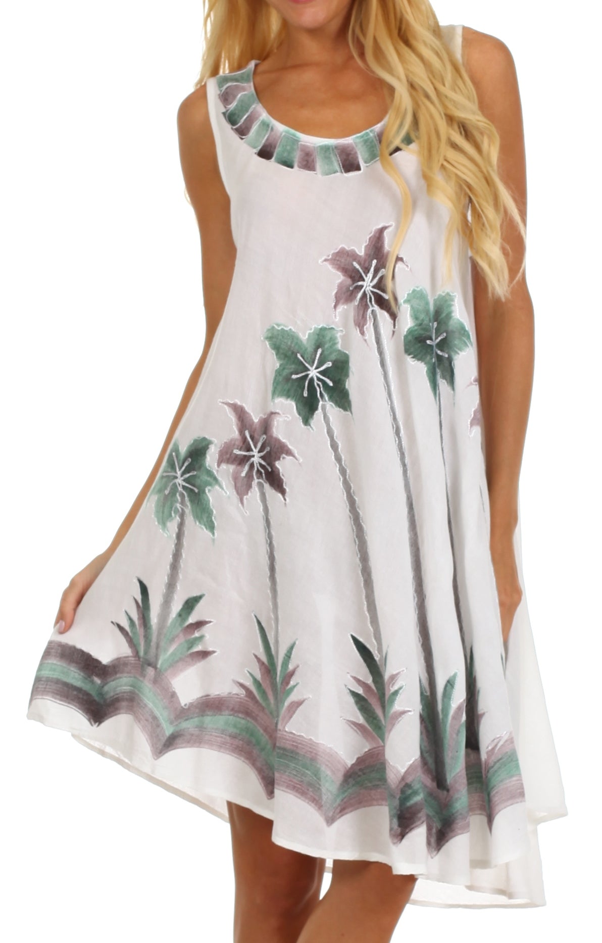 White dress with floral and palm tree patterns worn by a model on a white background