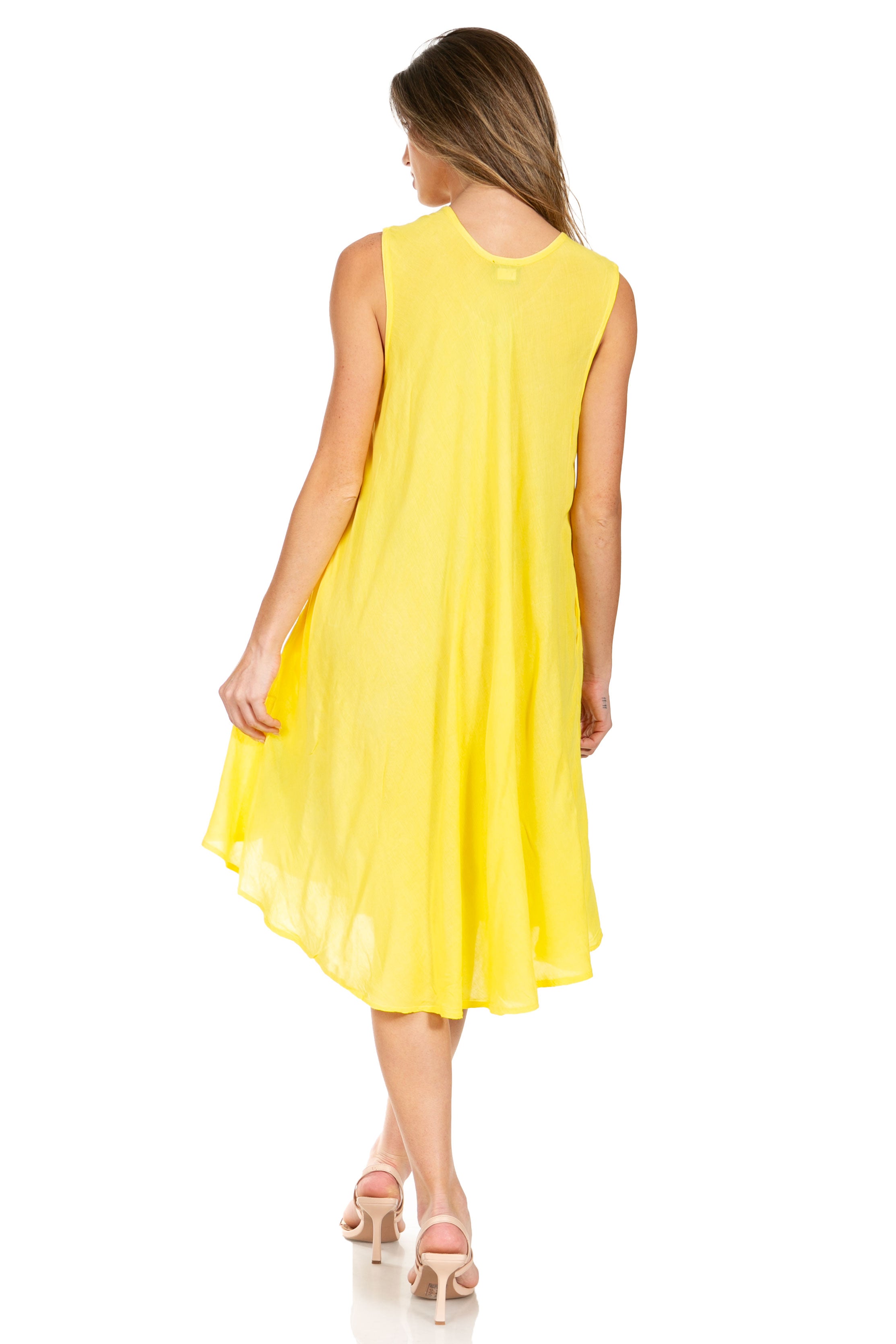 Woman wearing a yellow sleeveless dress on a white background