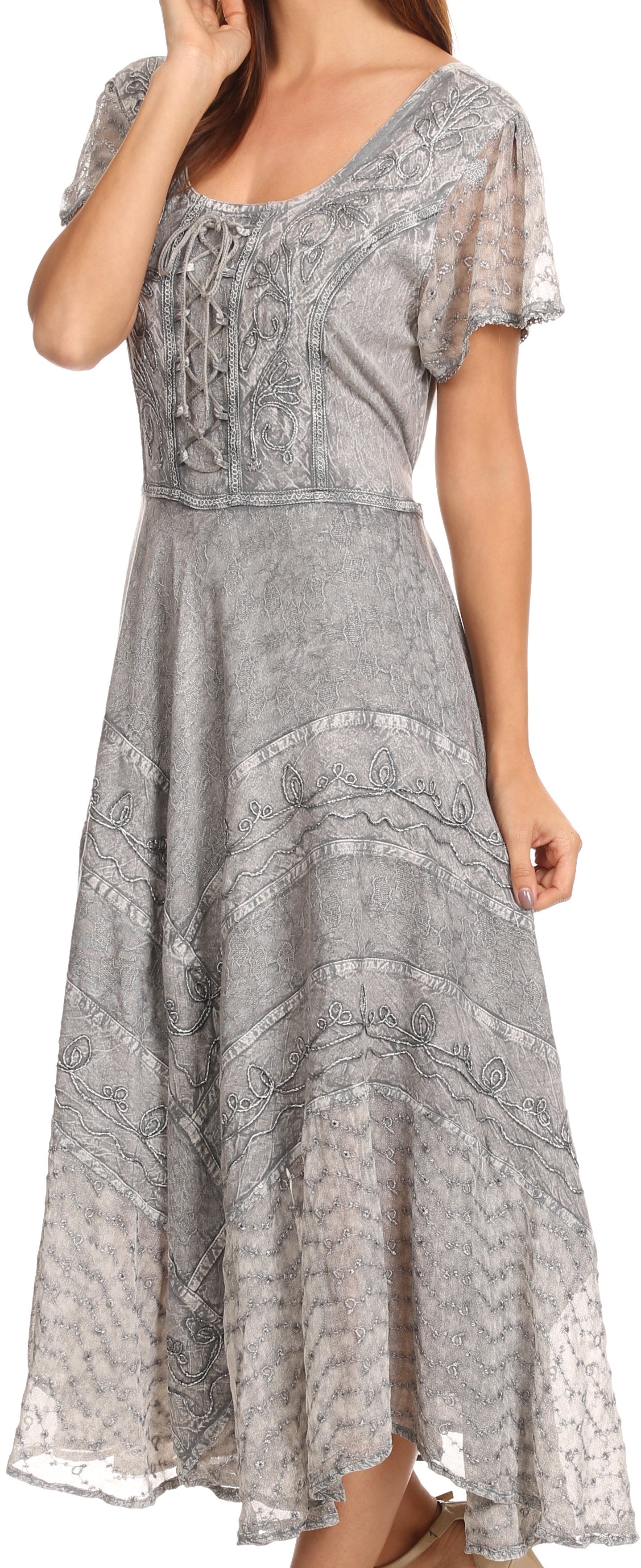 Woman wearing a long, patterned gray dress with lace details.