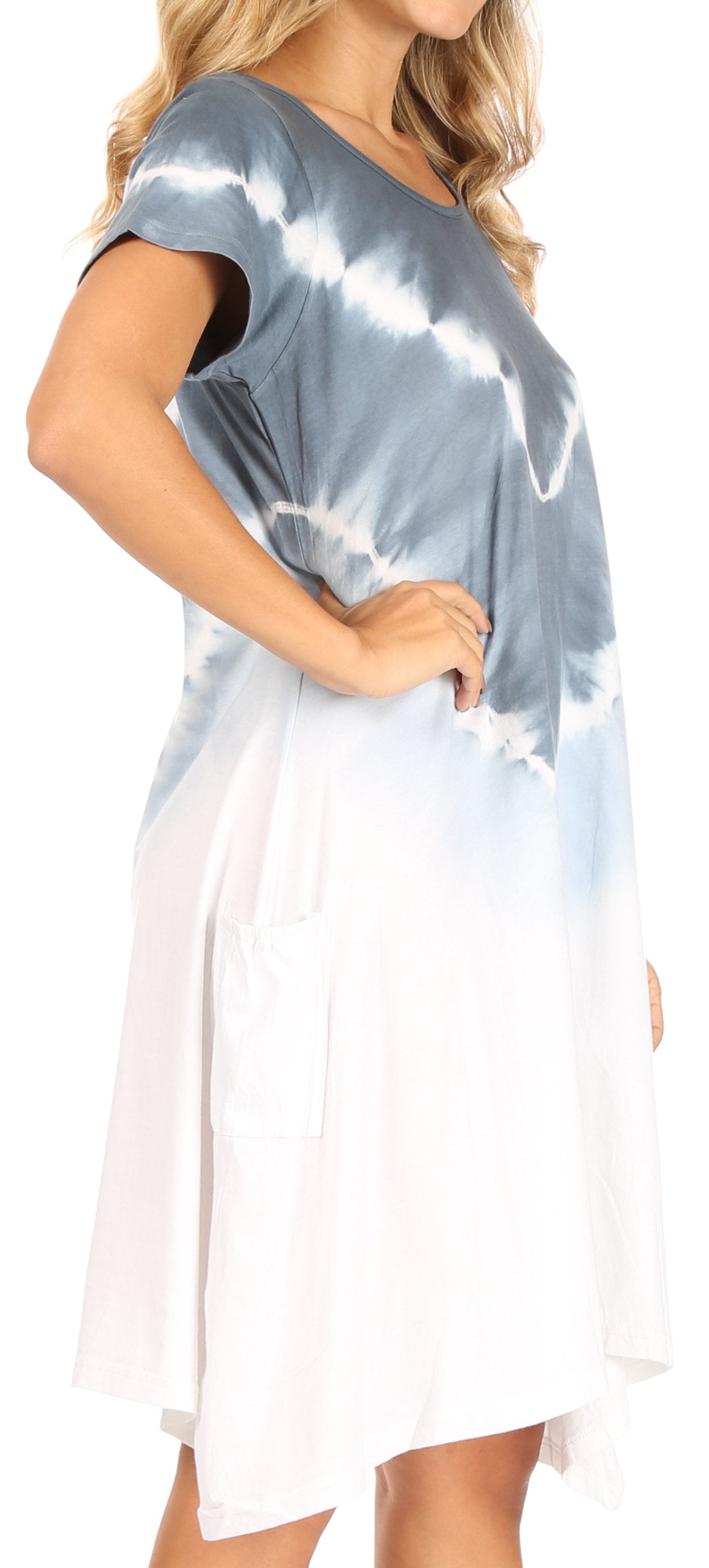 Woman wearing a tie-dye dress with a white bottom half on a plain background