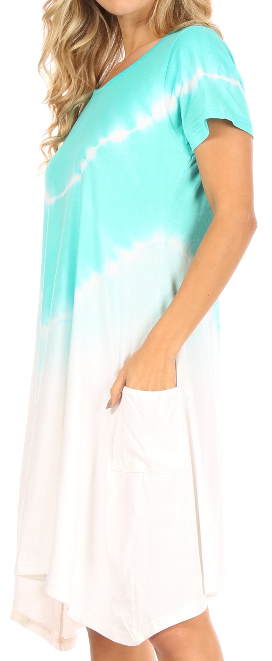 Woman wearing a tie-dye dress with a gradient from turquoise to white.