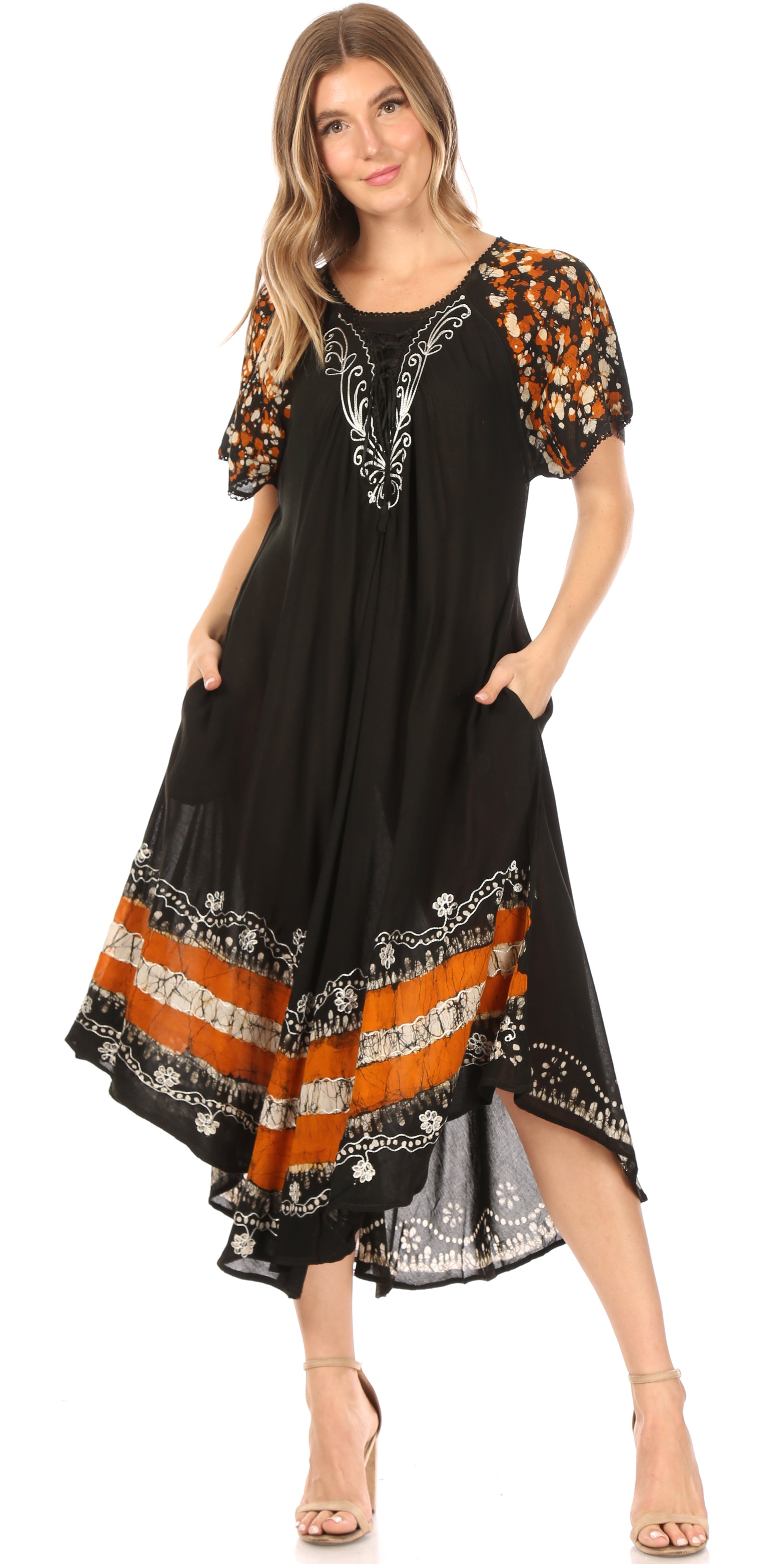 Woman wearing a black dress with orange and white patterns on a white background