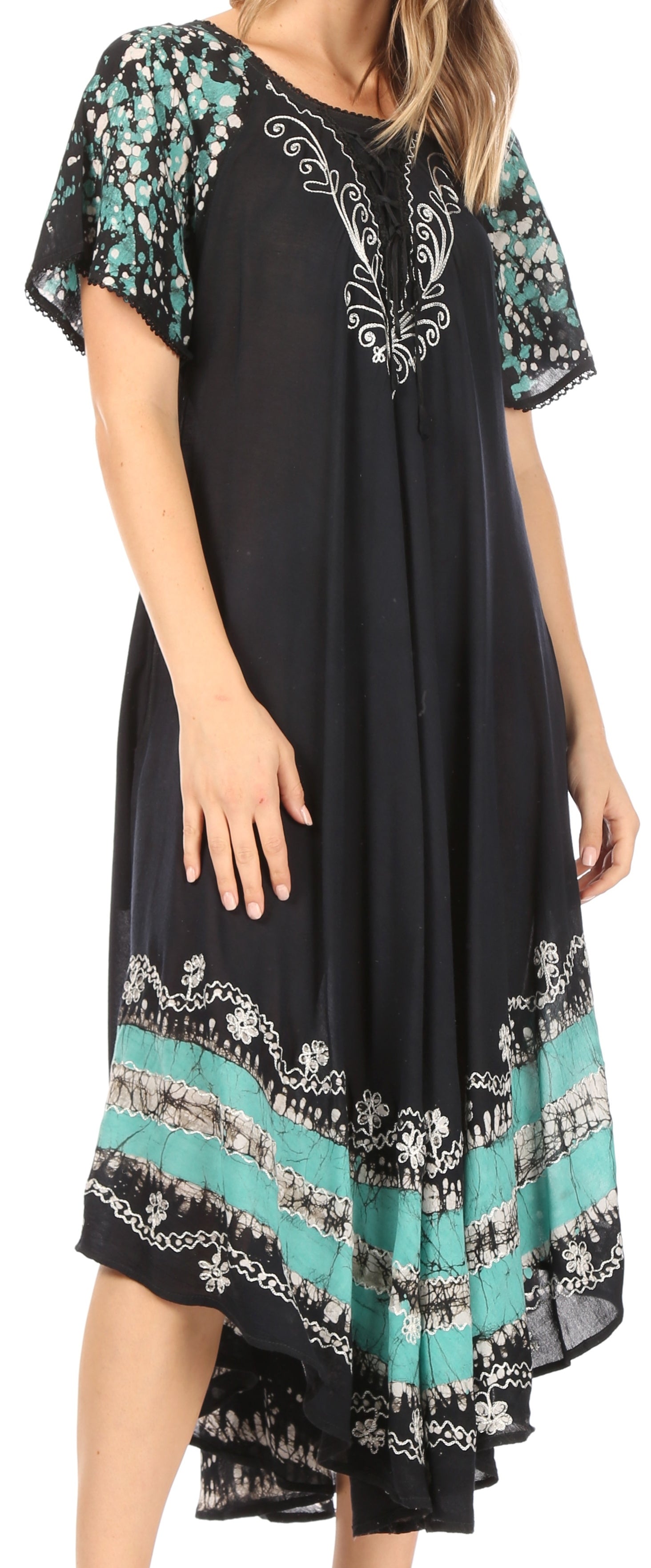 Black dress with floral patterns on sleeves and hem, worn by a model.