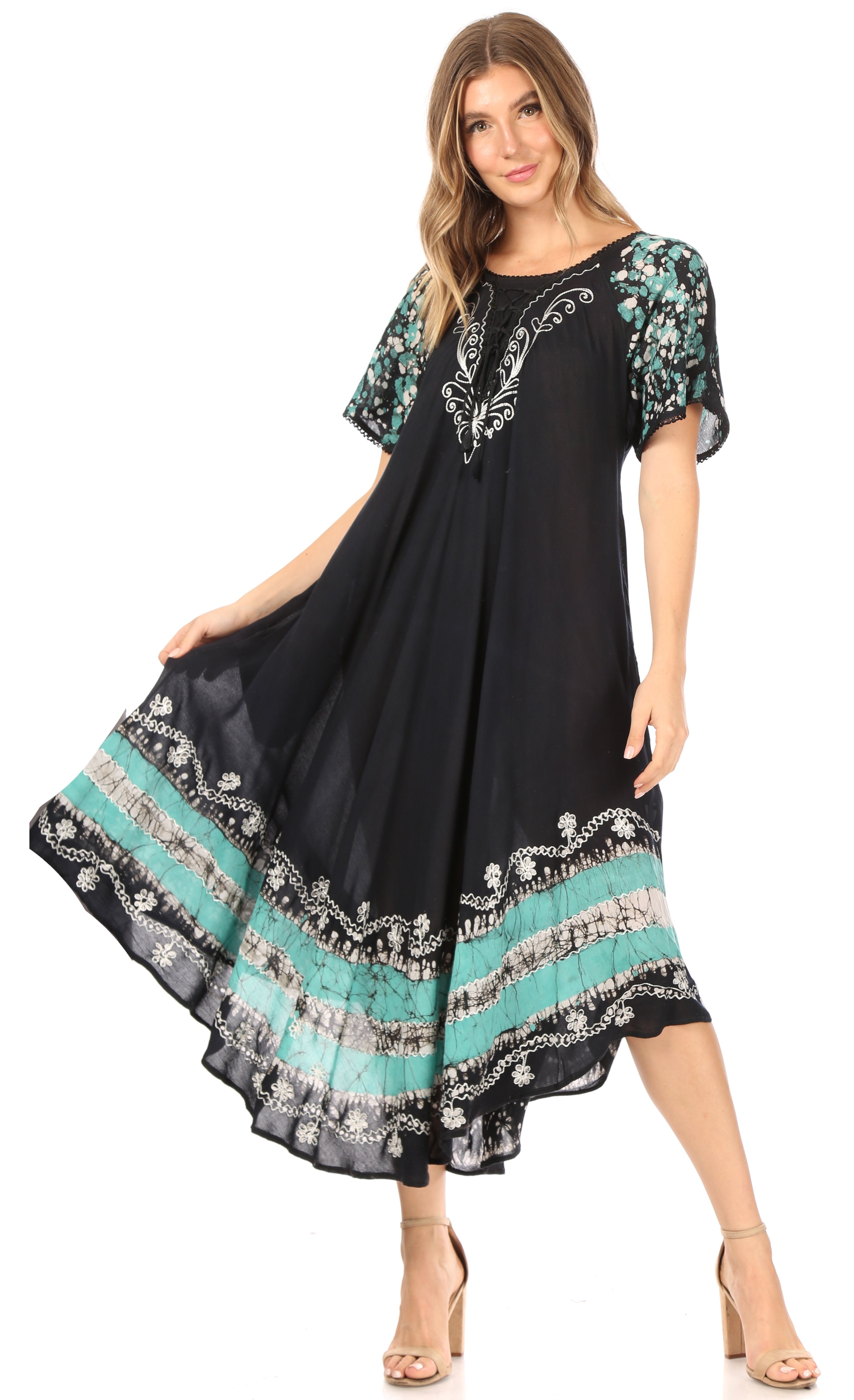 Woman wearing a black dress with floral patterns on a white background