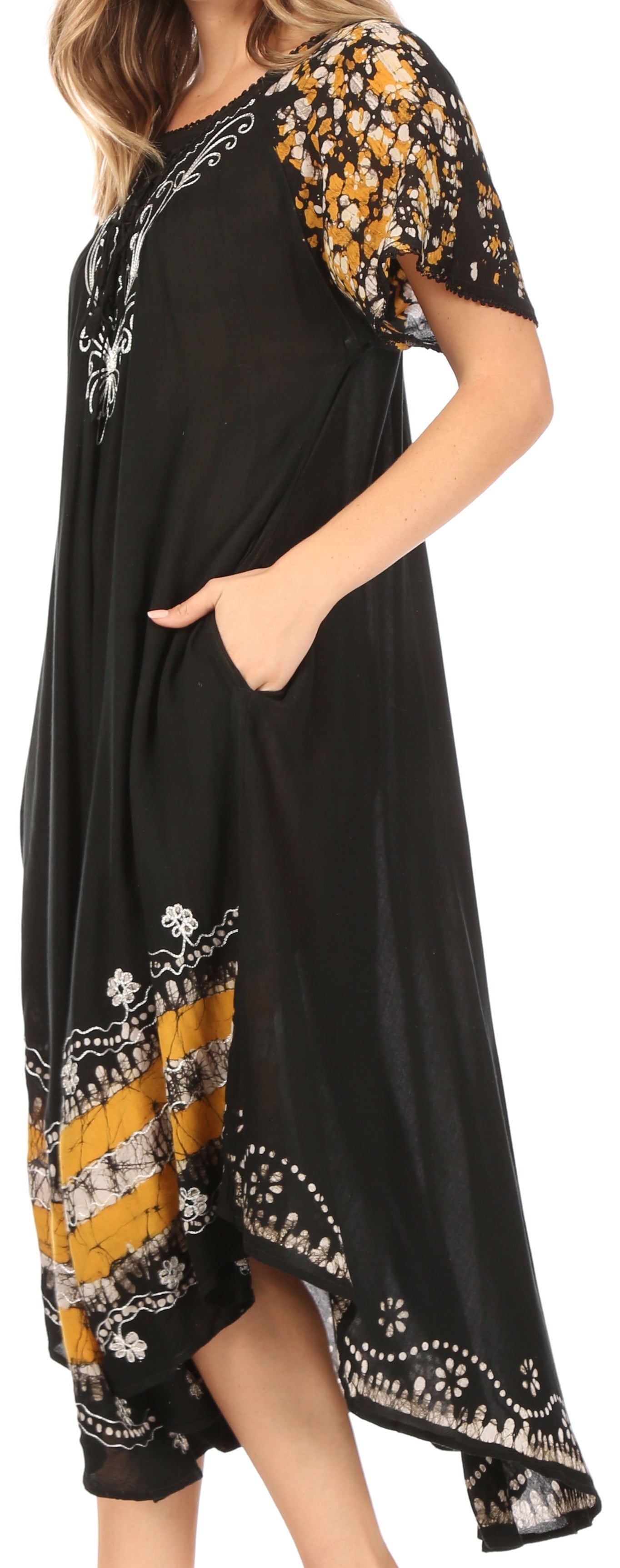 Black dress with yellow and white floral patterns on a plain background