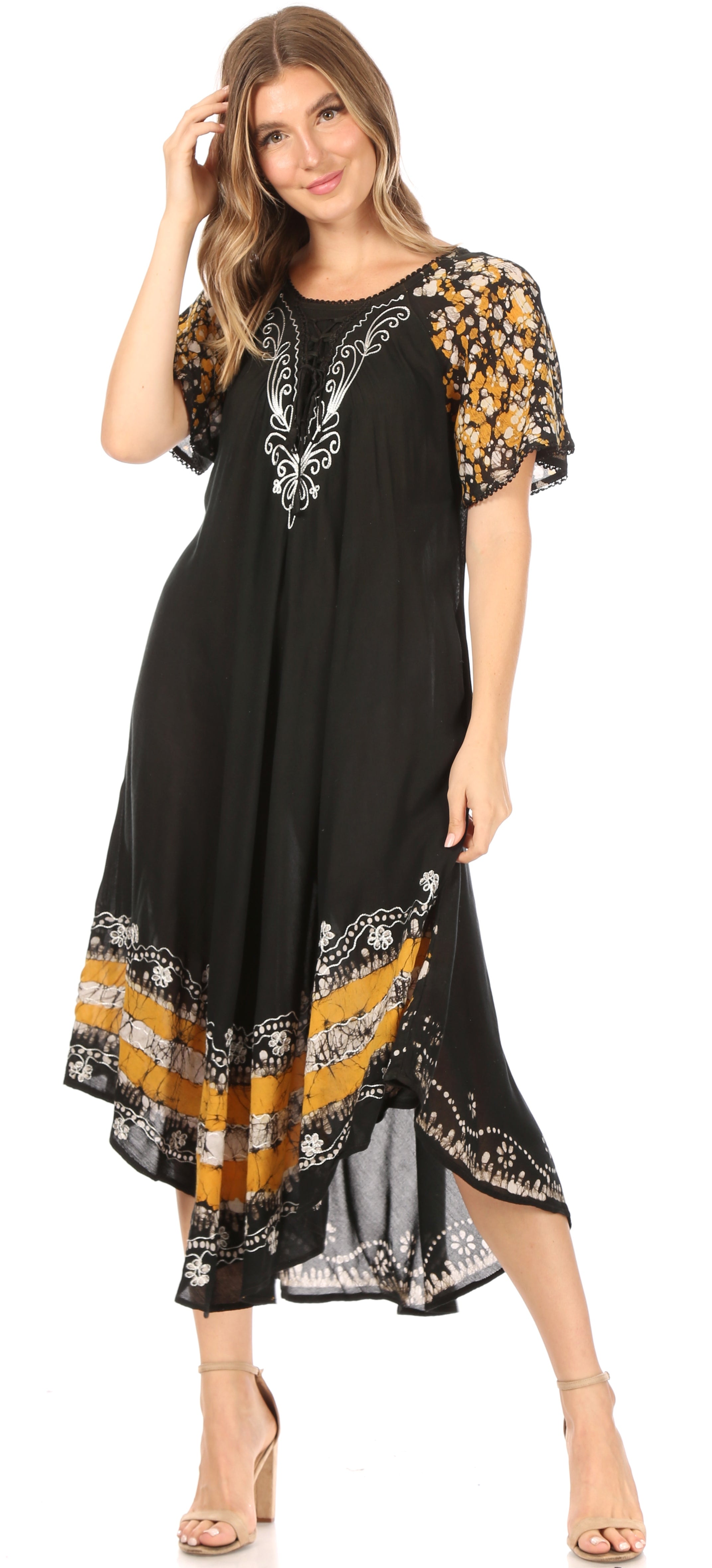 Woman wearing a black dress with floral patterns on a white background