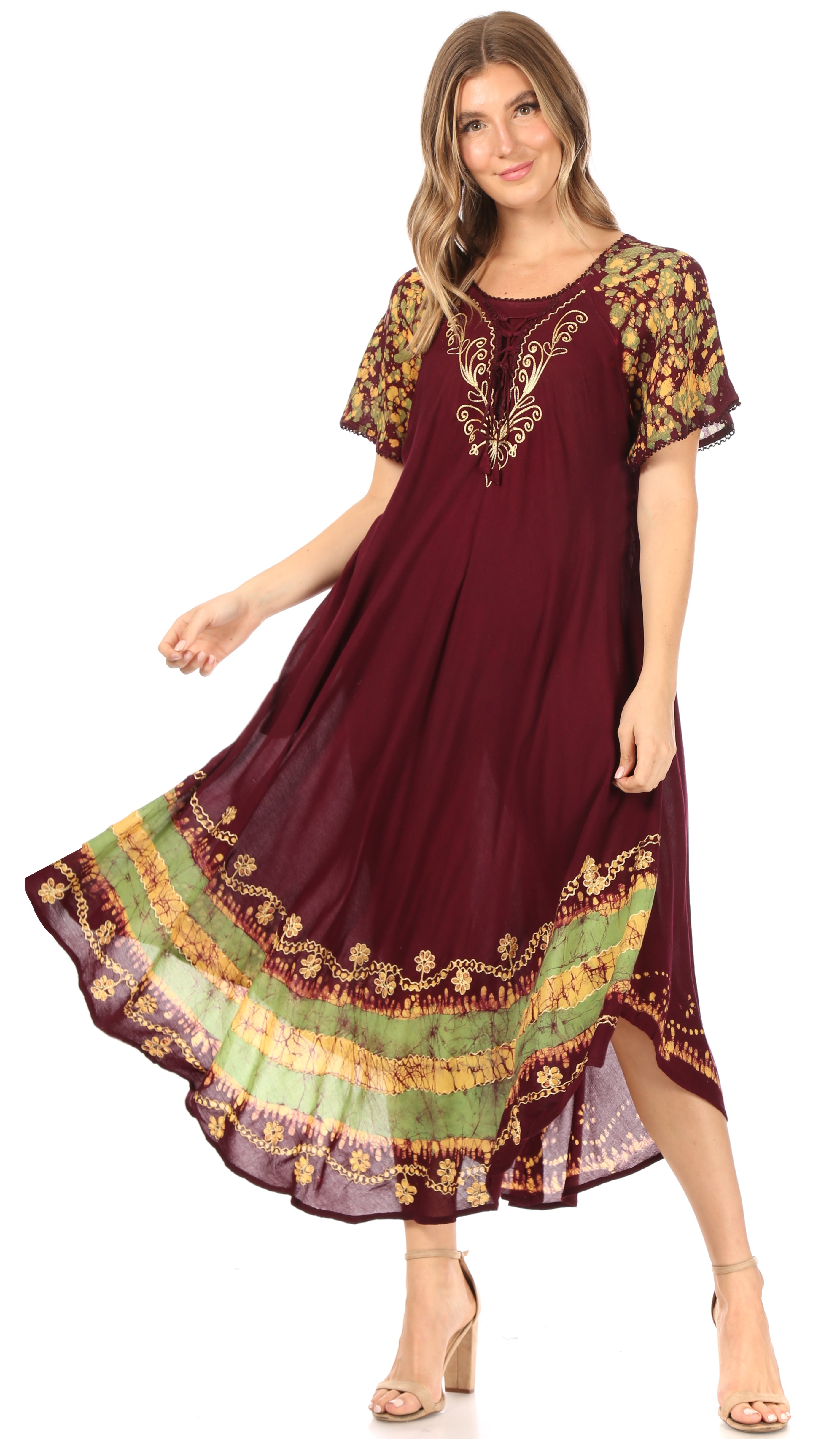 Woman wearing a burgundy dress with colorful embroidery on a white background