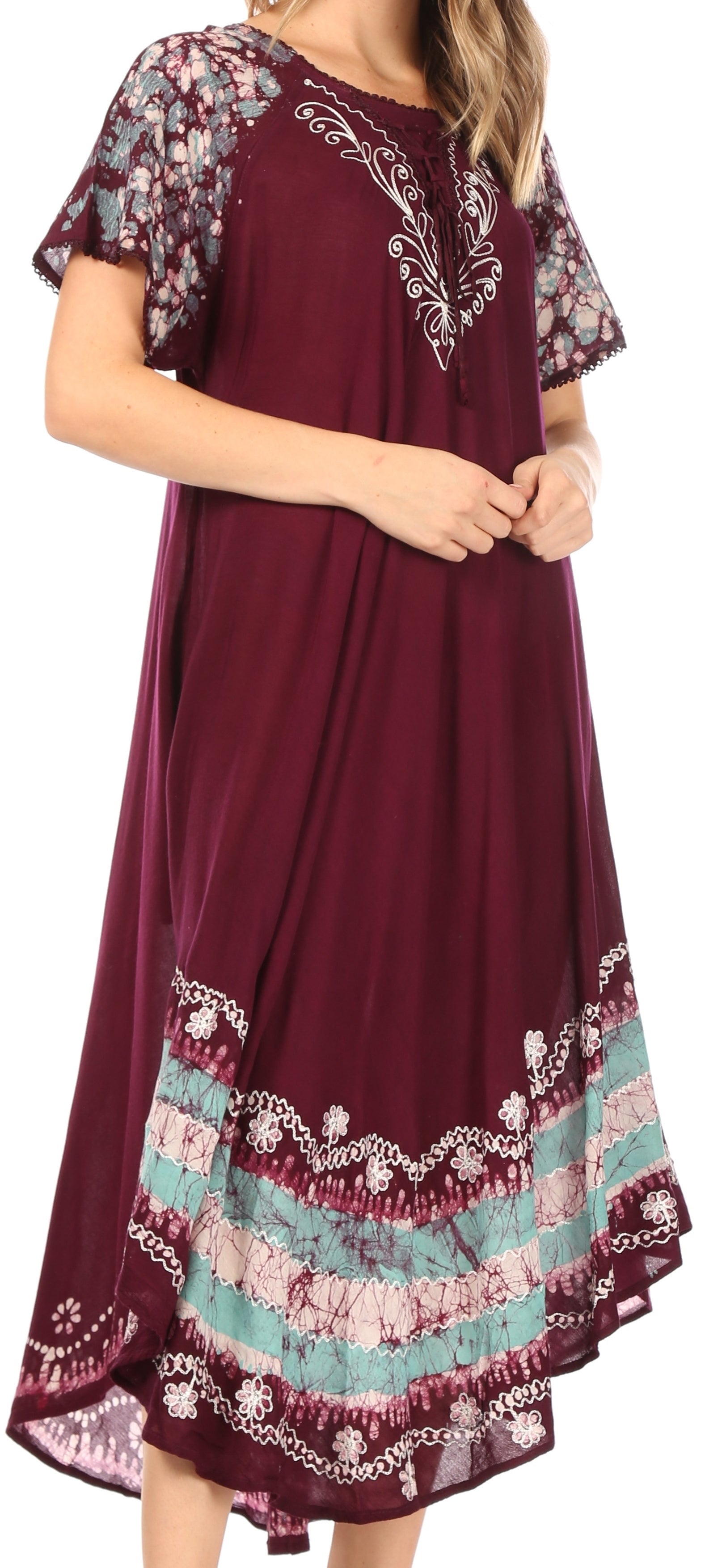 Maroon dress with floral embroidery and colorful hem on a plain background