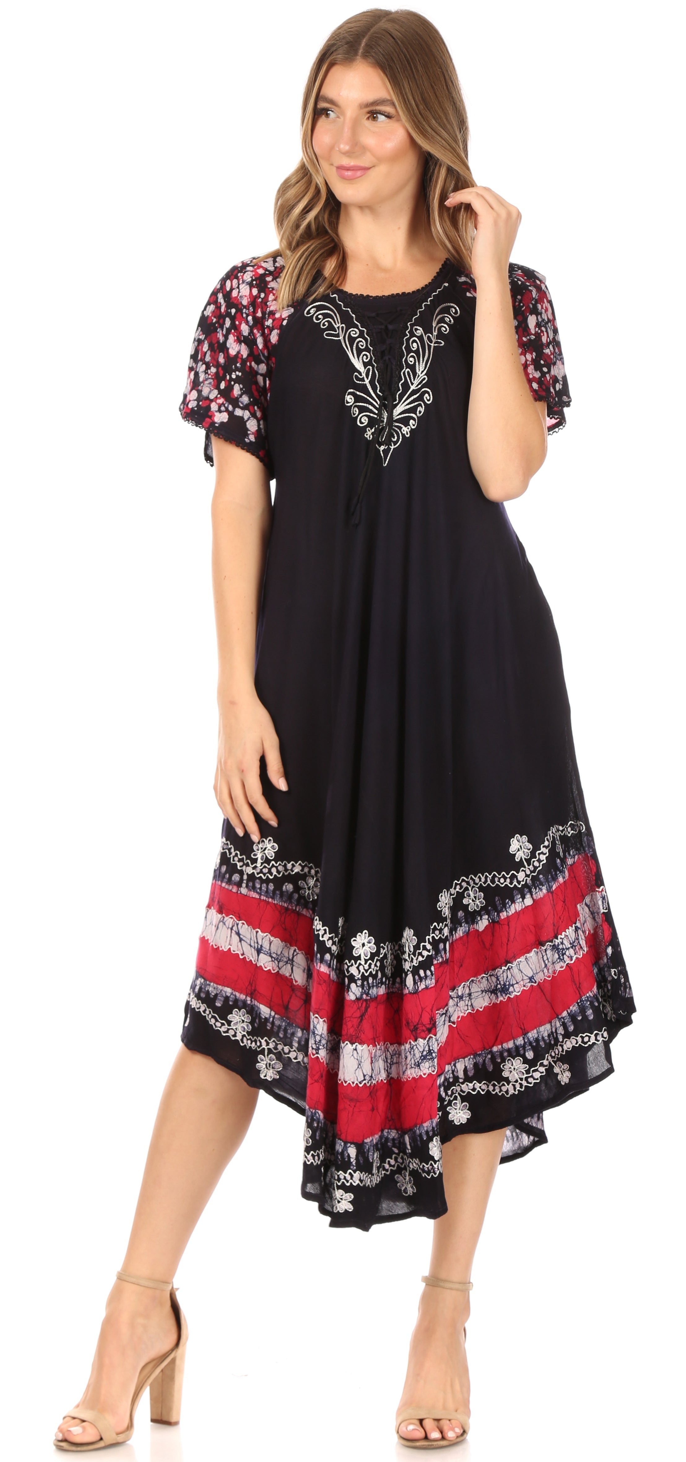 Woman wearing a black dress with floral sleeves and red patterns on a white background