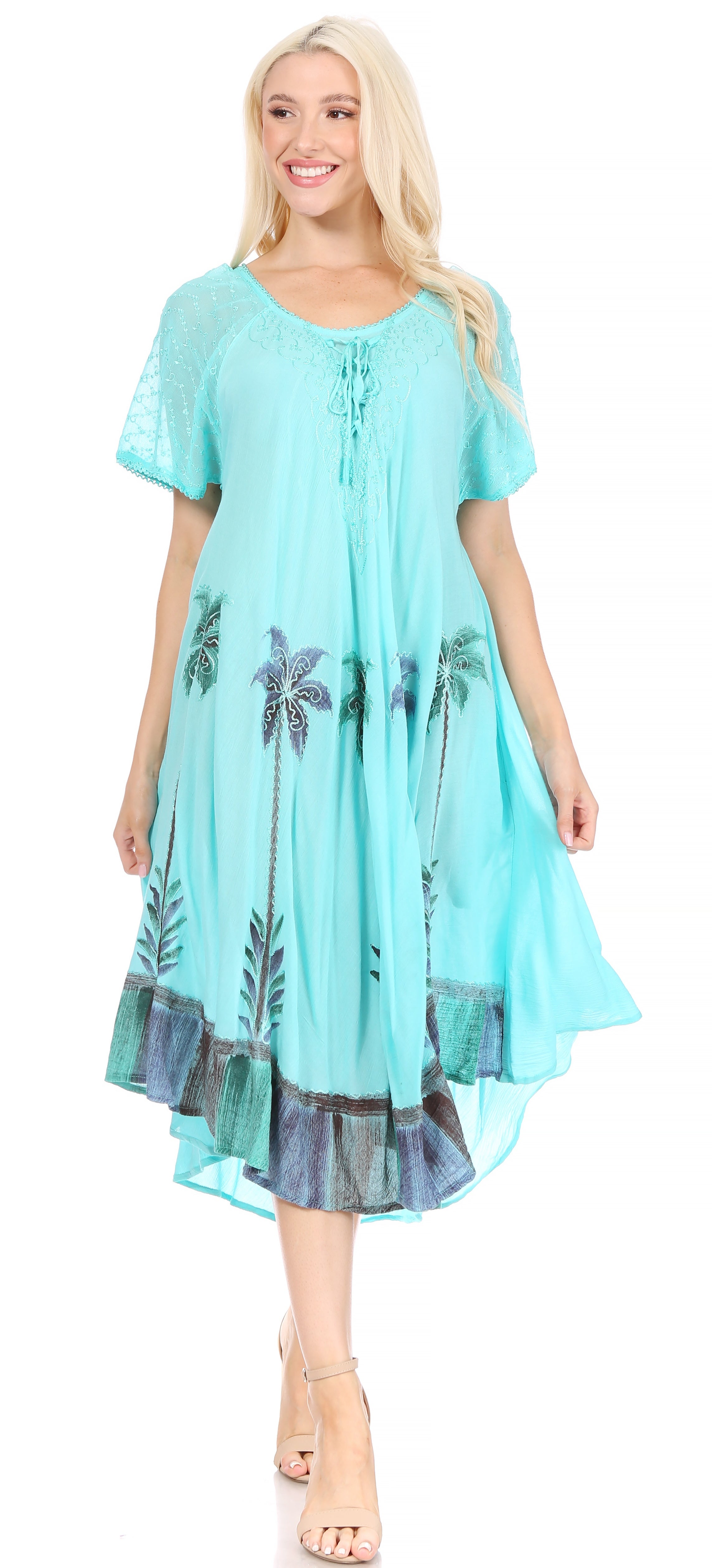 Woman wearing a light blue dress with palm tree patterns on a white background