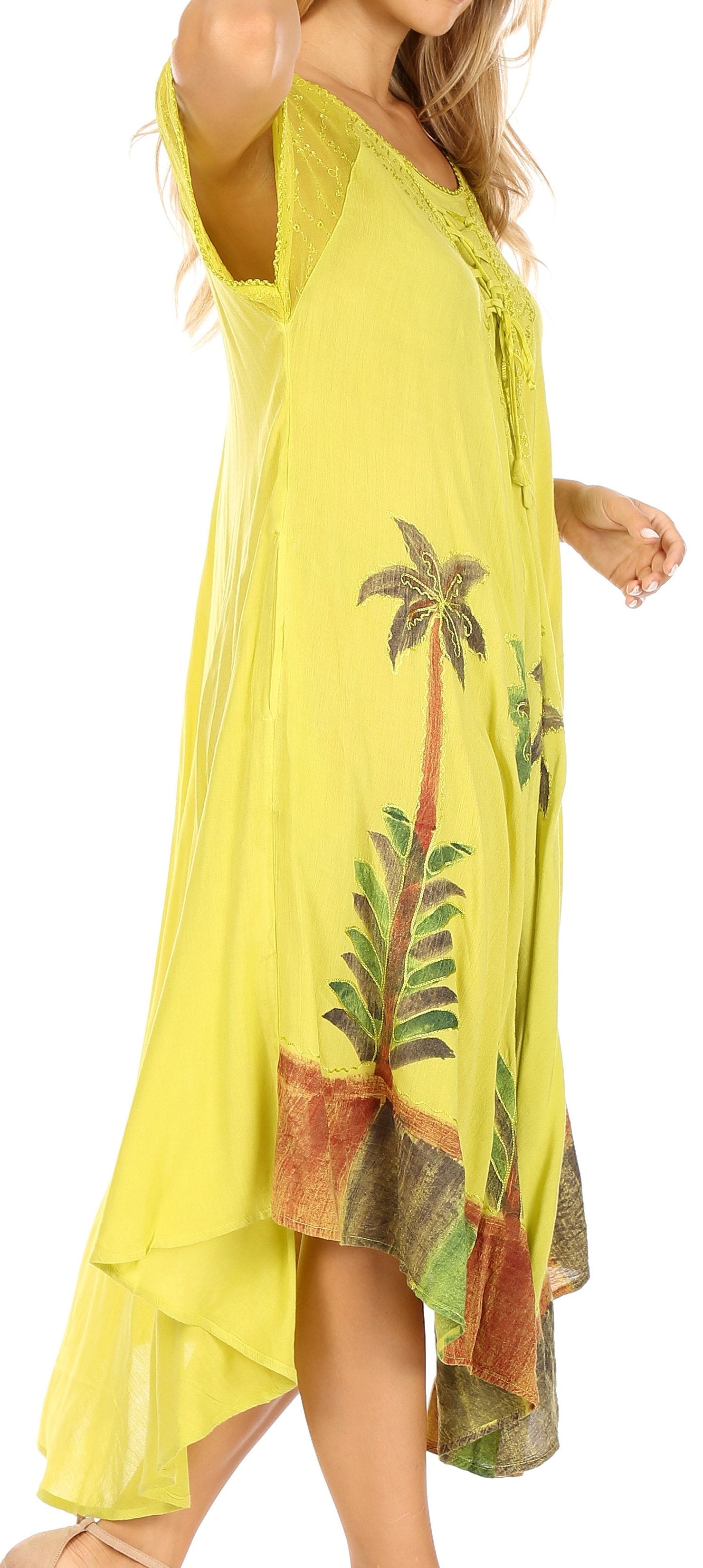 Yellow dress with palm tree pattern worn by a person on a white background