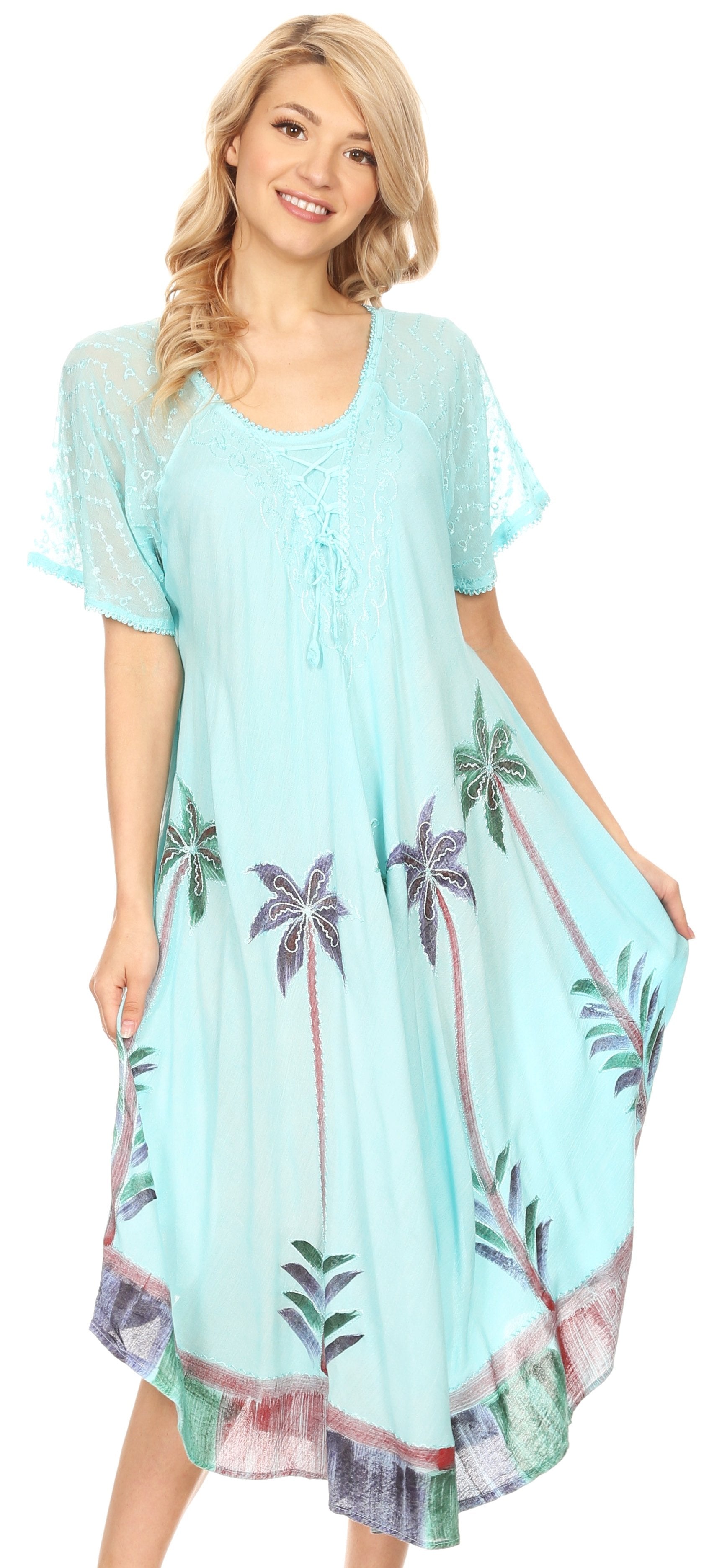 Woman wearing a light blue dress with palm tree patterns