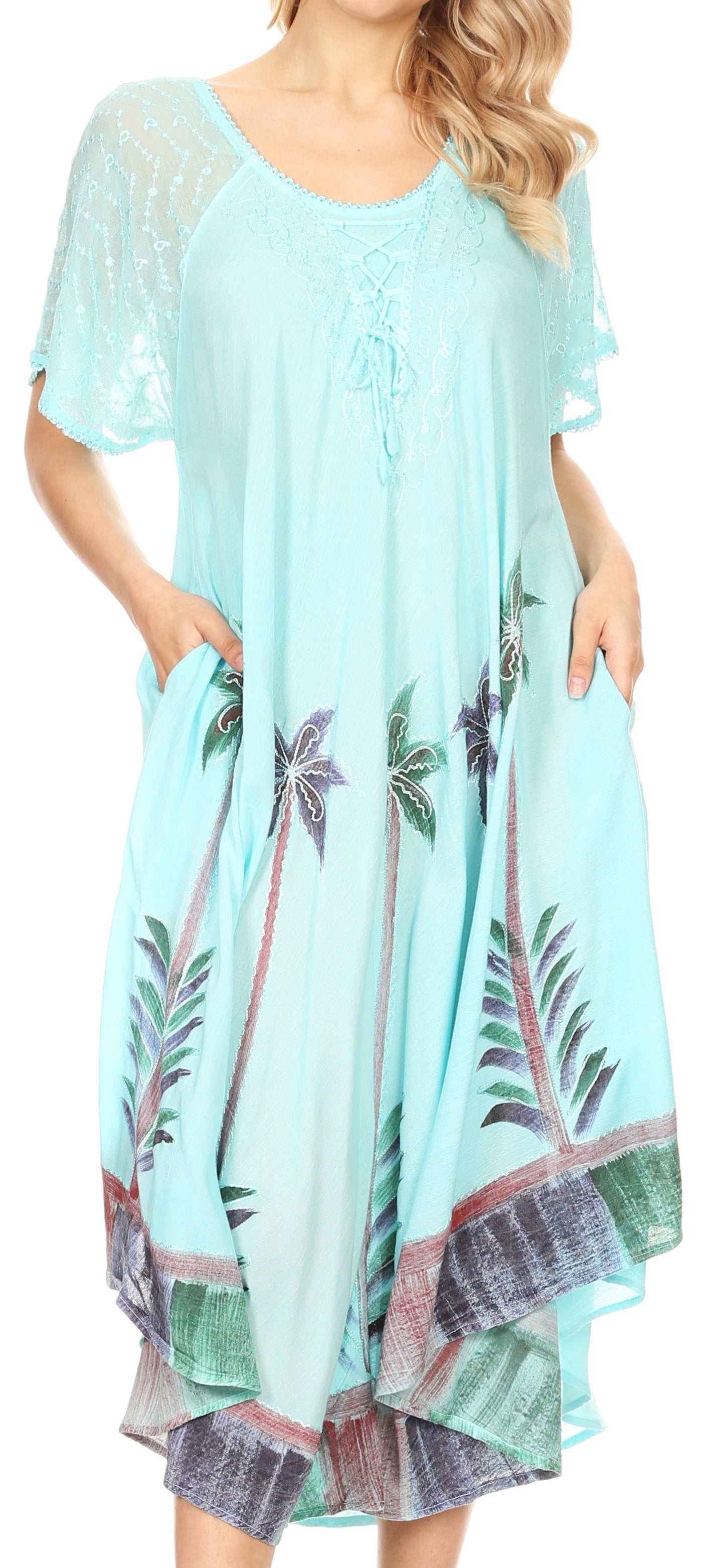 Woman wearing a light blue dress with palm tree print