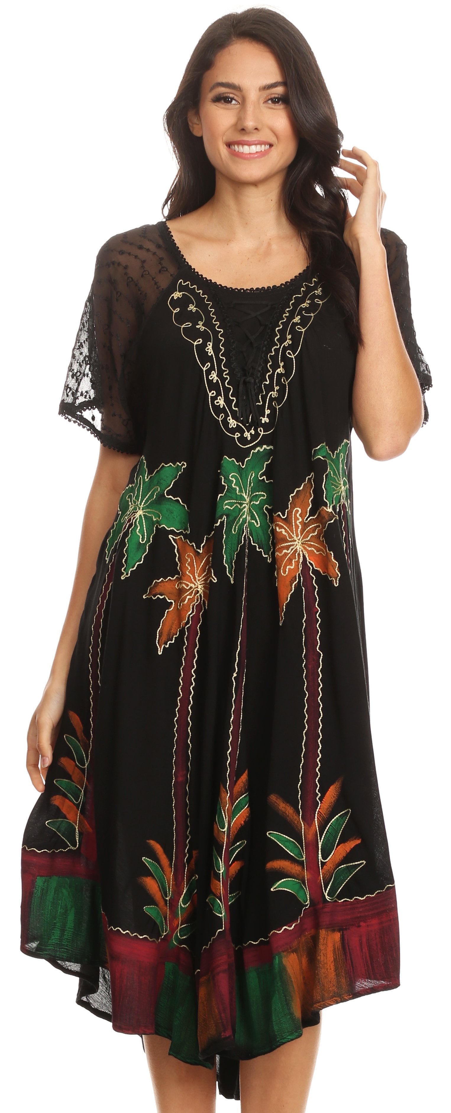 Woman wearing a black dress with colorful leaf patterns on a plain background