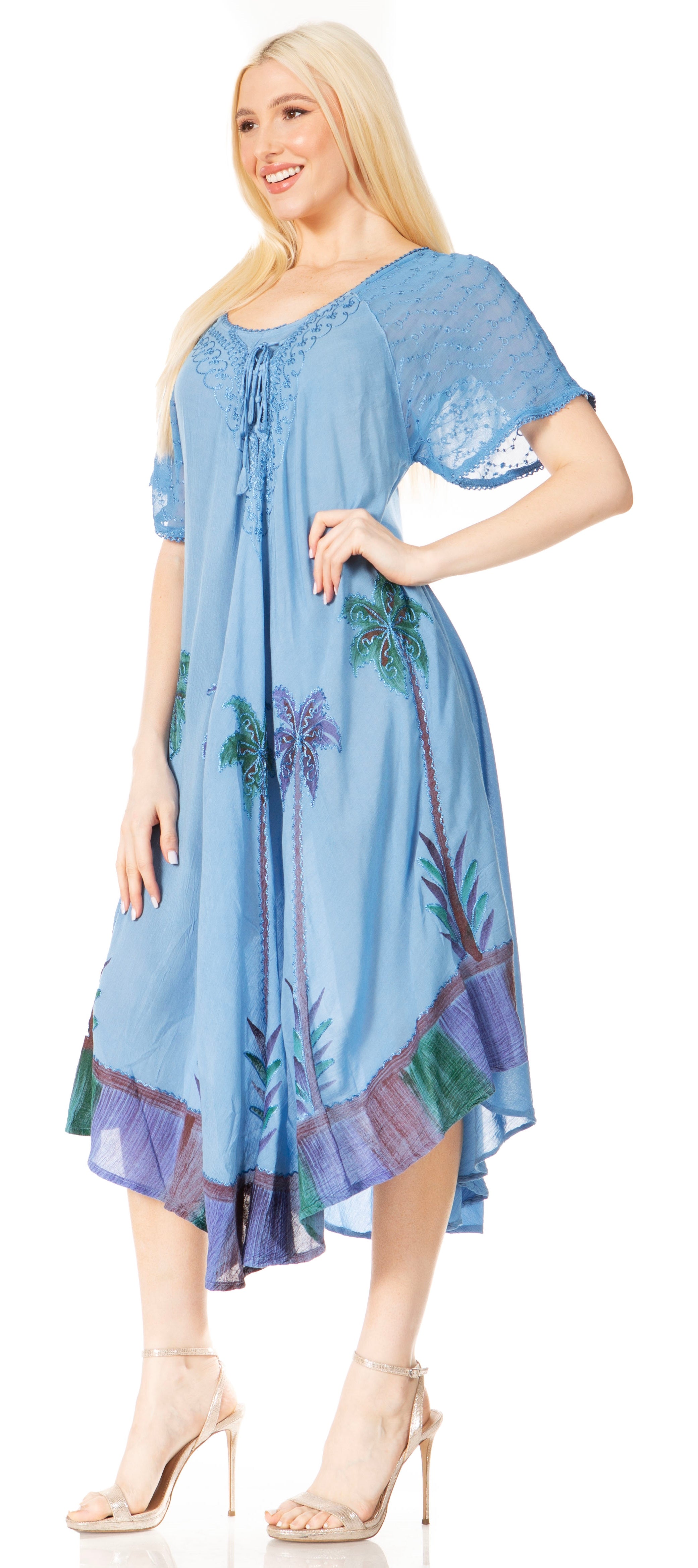 Woman wearing a blue floral dress against a white background