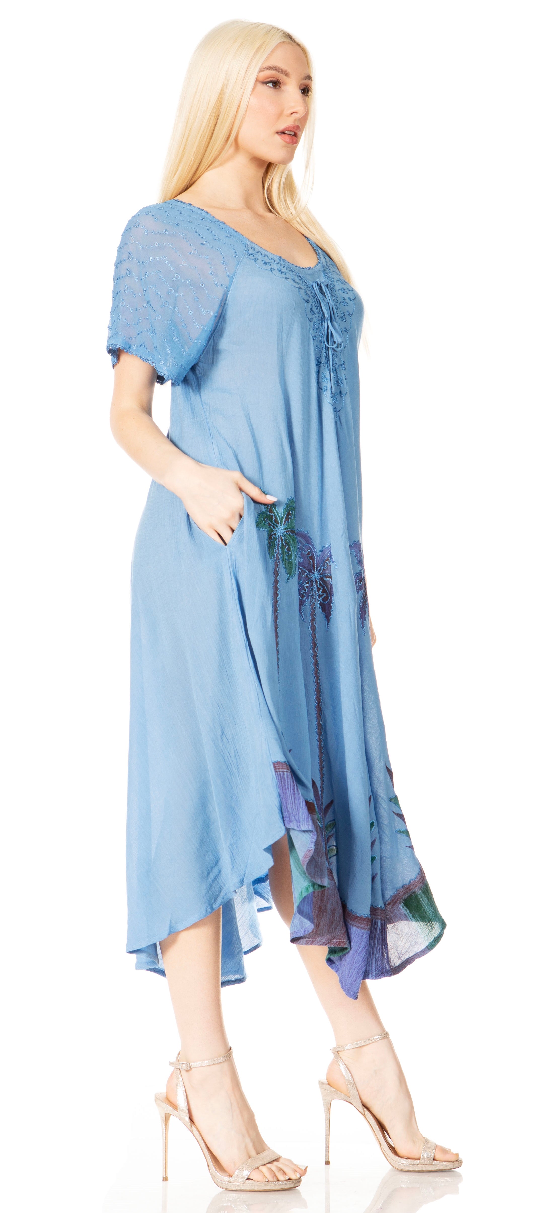 Woman wearing a blue dress with floral patterns on a white background