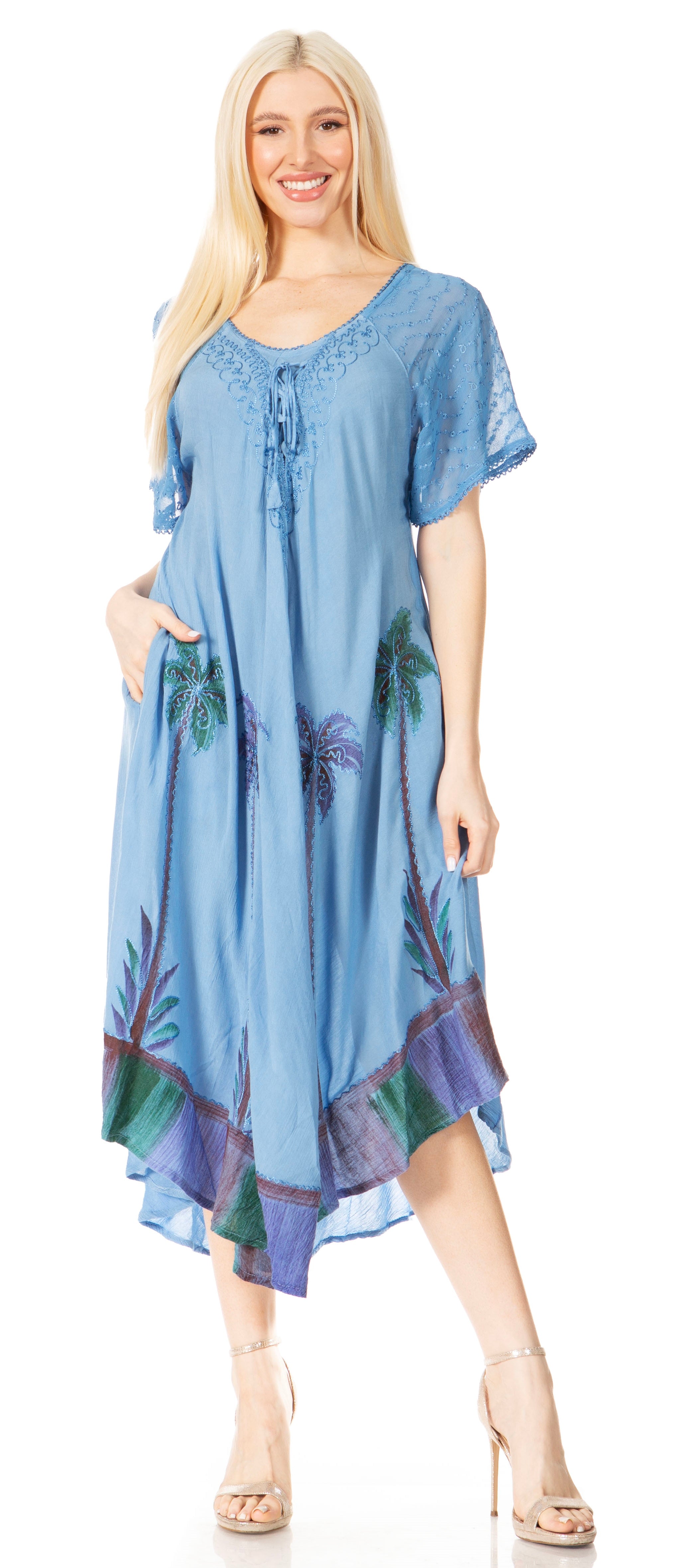 Woman wearing a blue dress with floral patterns on a white background