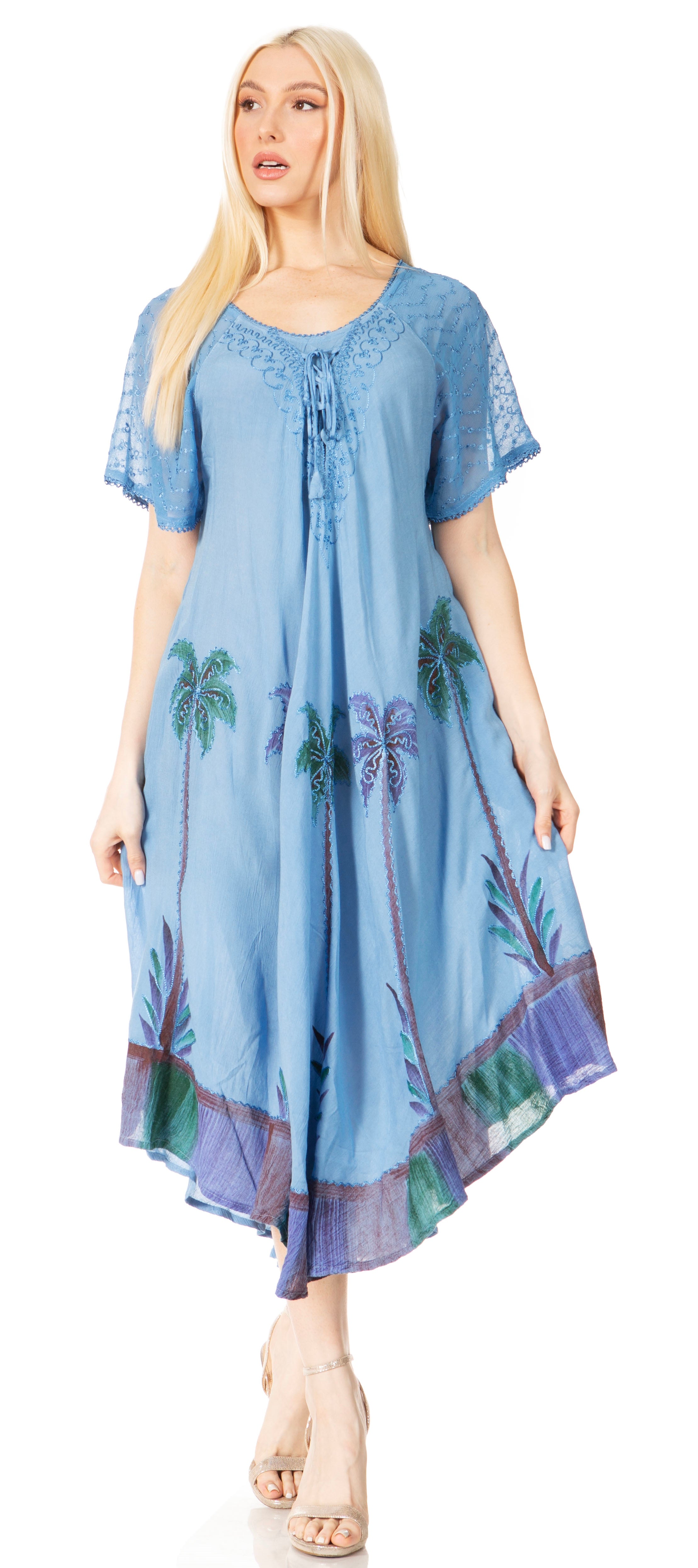 Woman wearing a blue dress with palm tree patterns on a white background