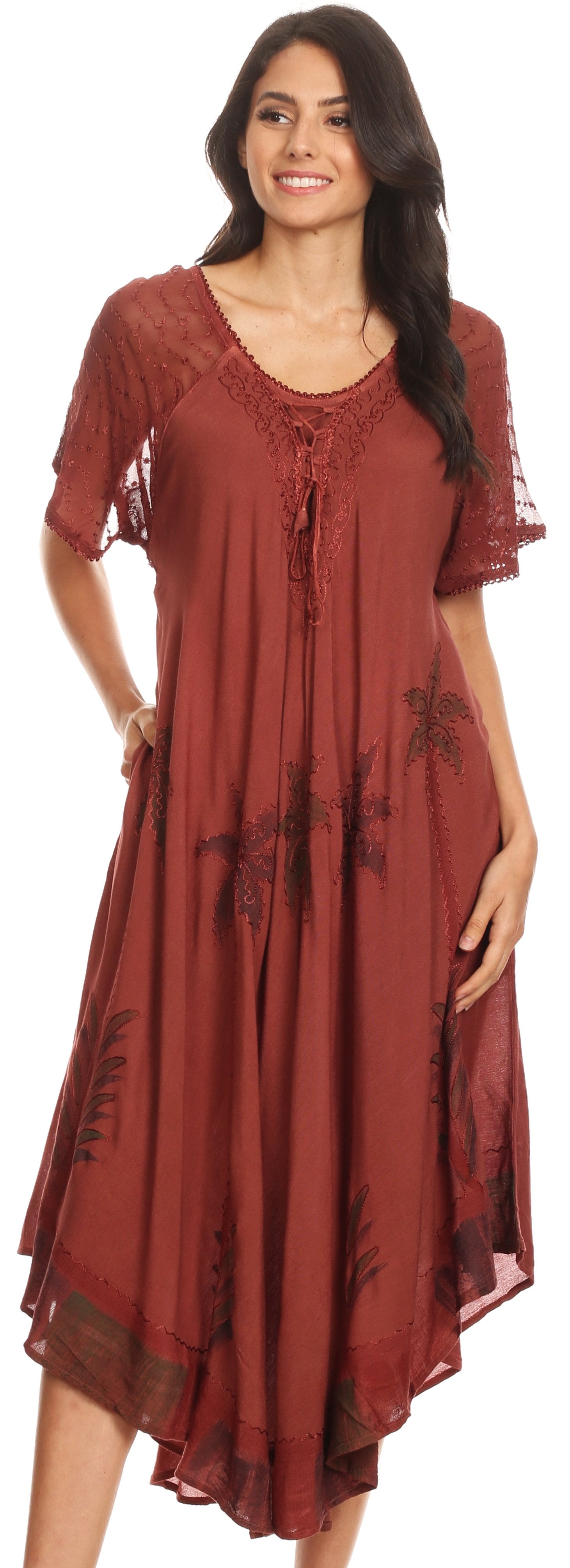 Woman wearing a rust-colored dress with lace details on a white background