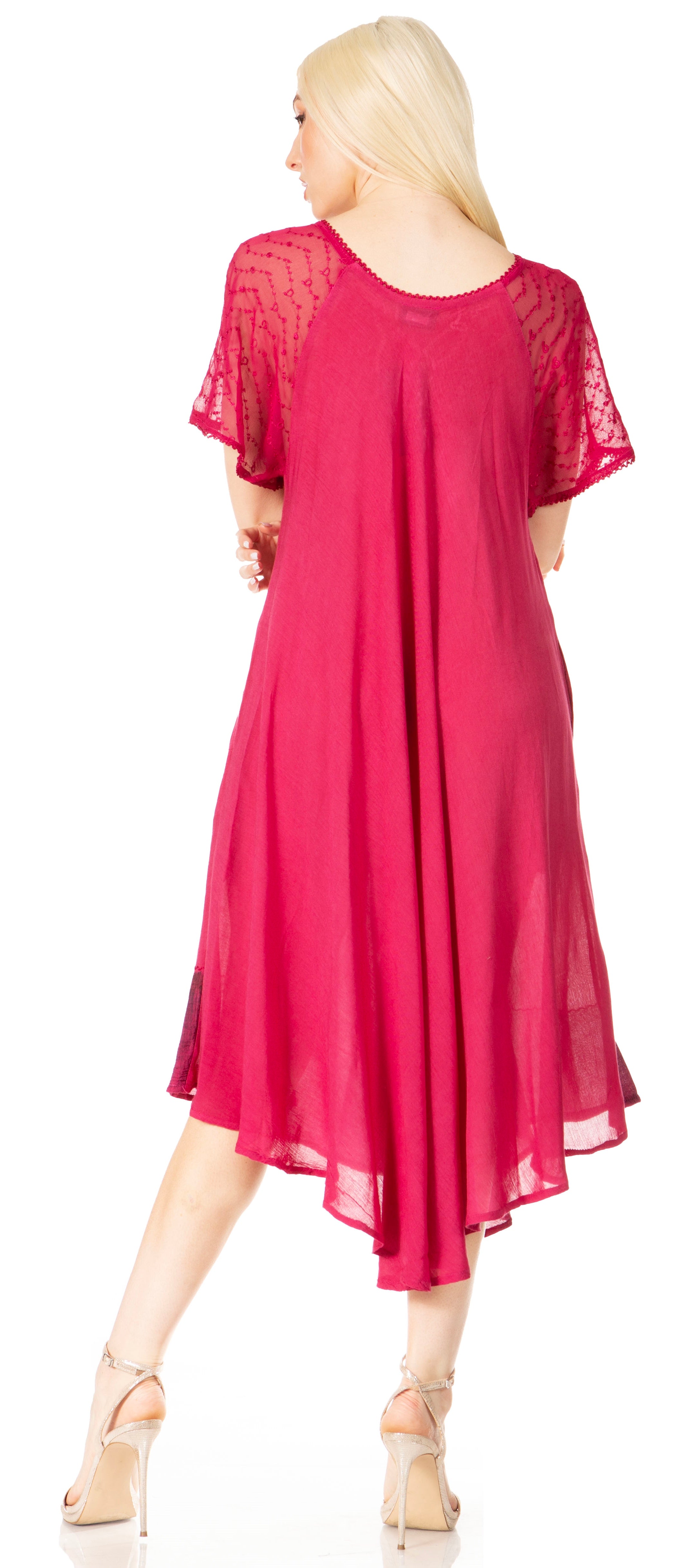 Woman wearing a pink dress with lace sleeves on a white background