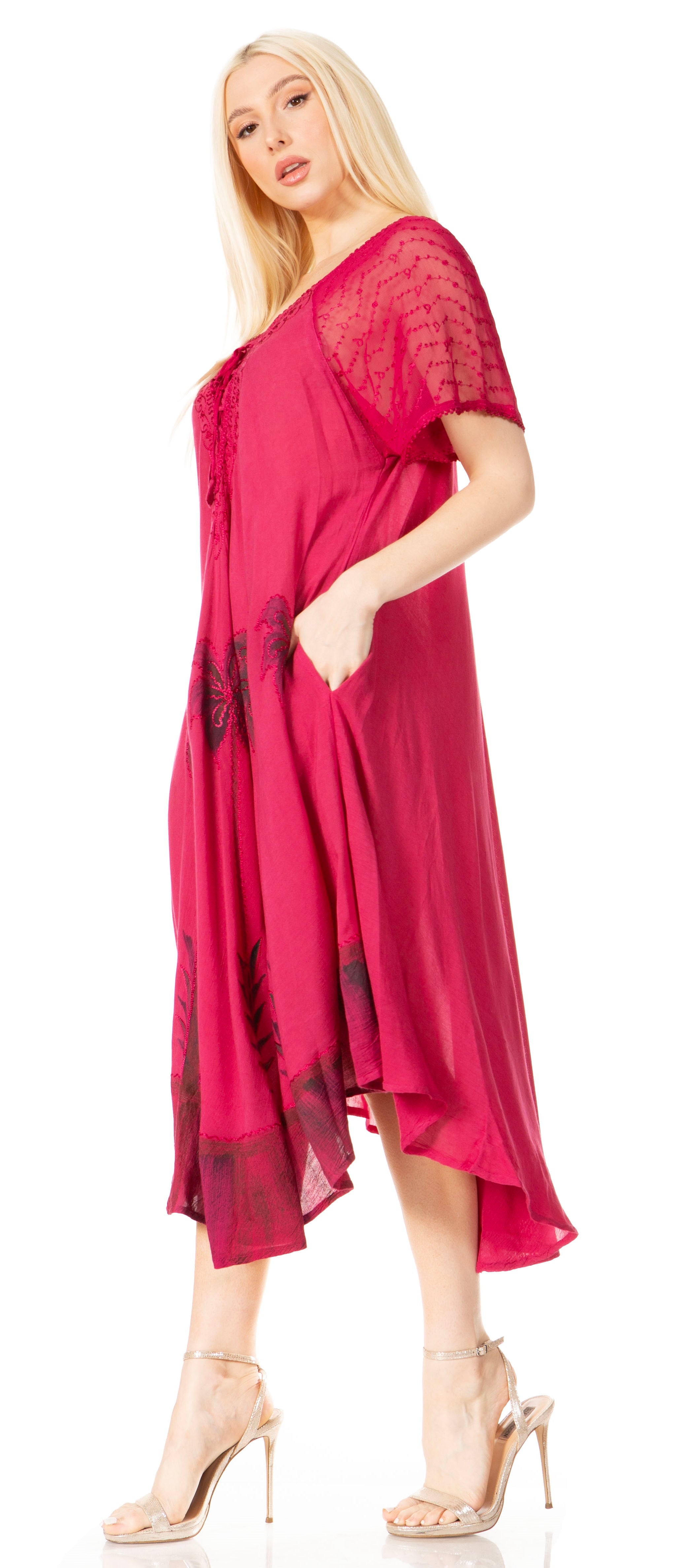 Woman wearing a red dress with black lace details on a white background