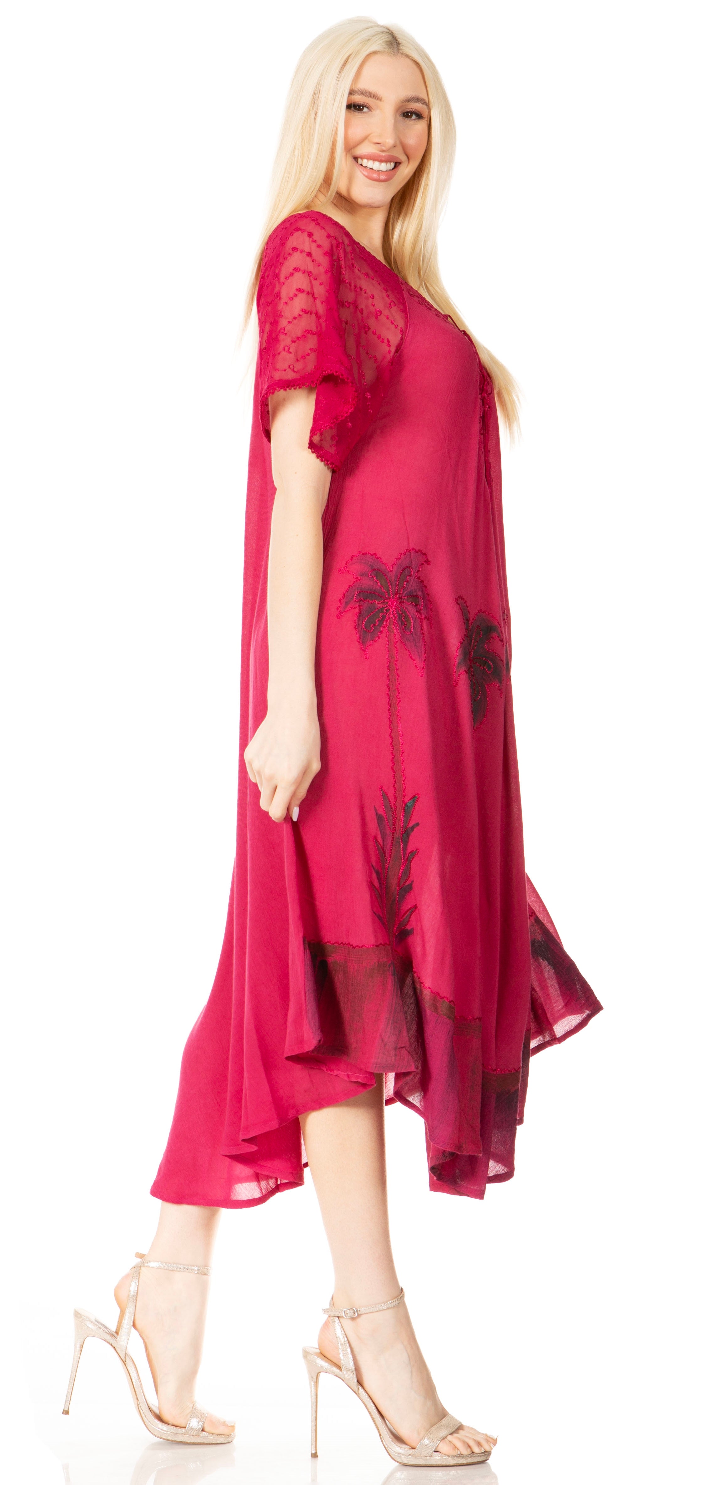 Woman wearing a pink dress with black floral patterns on a white background