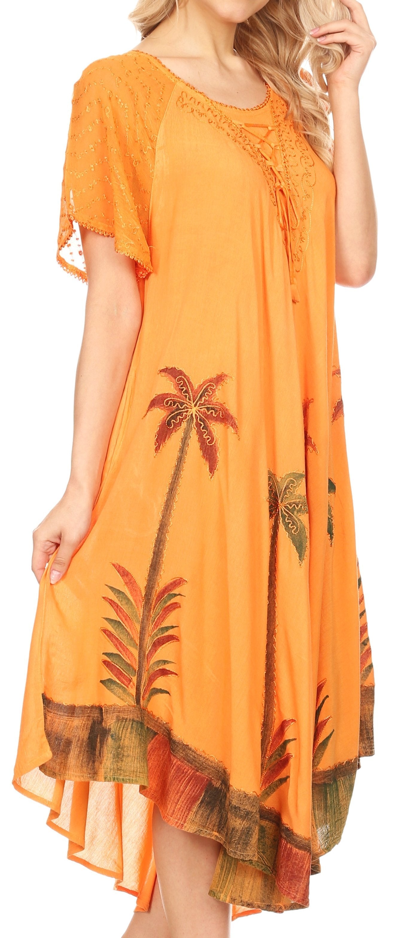 Orange dress with palm tree patterns worn by a model
