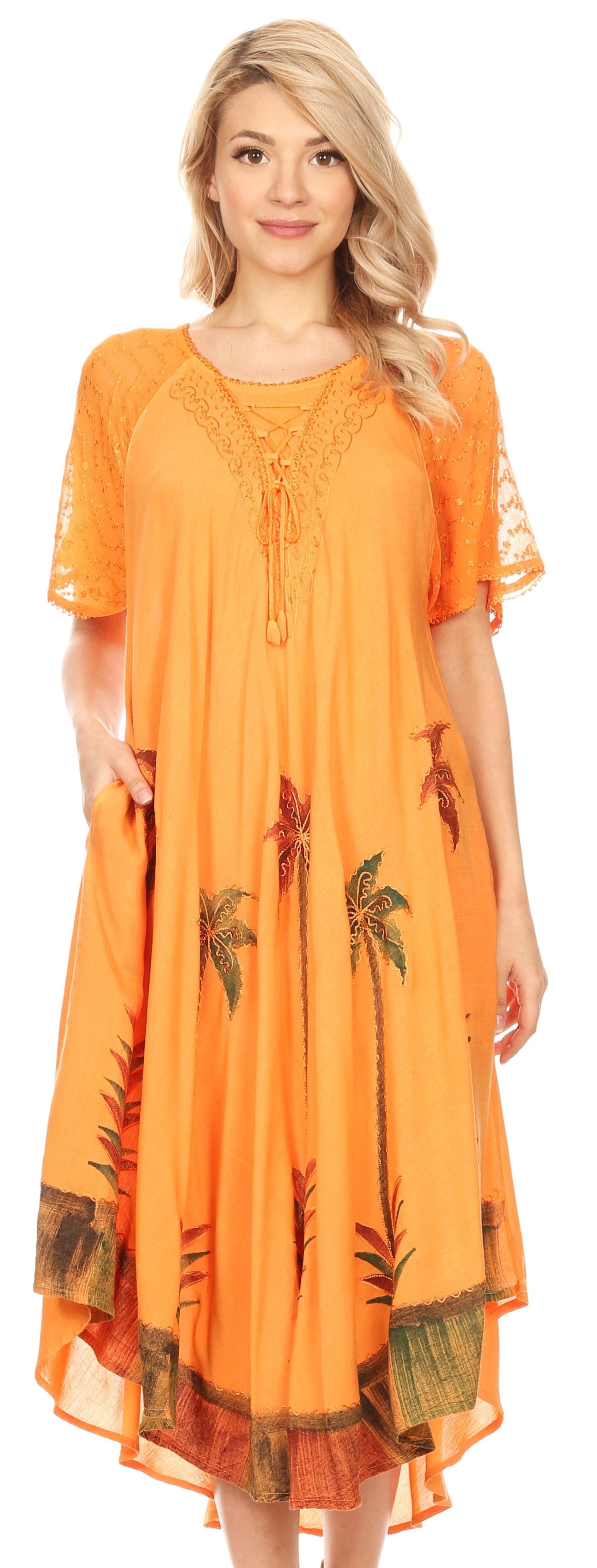 Woman wearing an orange dress with palm tree patterns on a white background