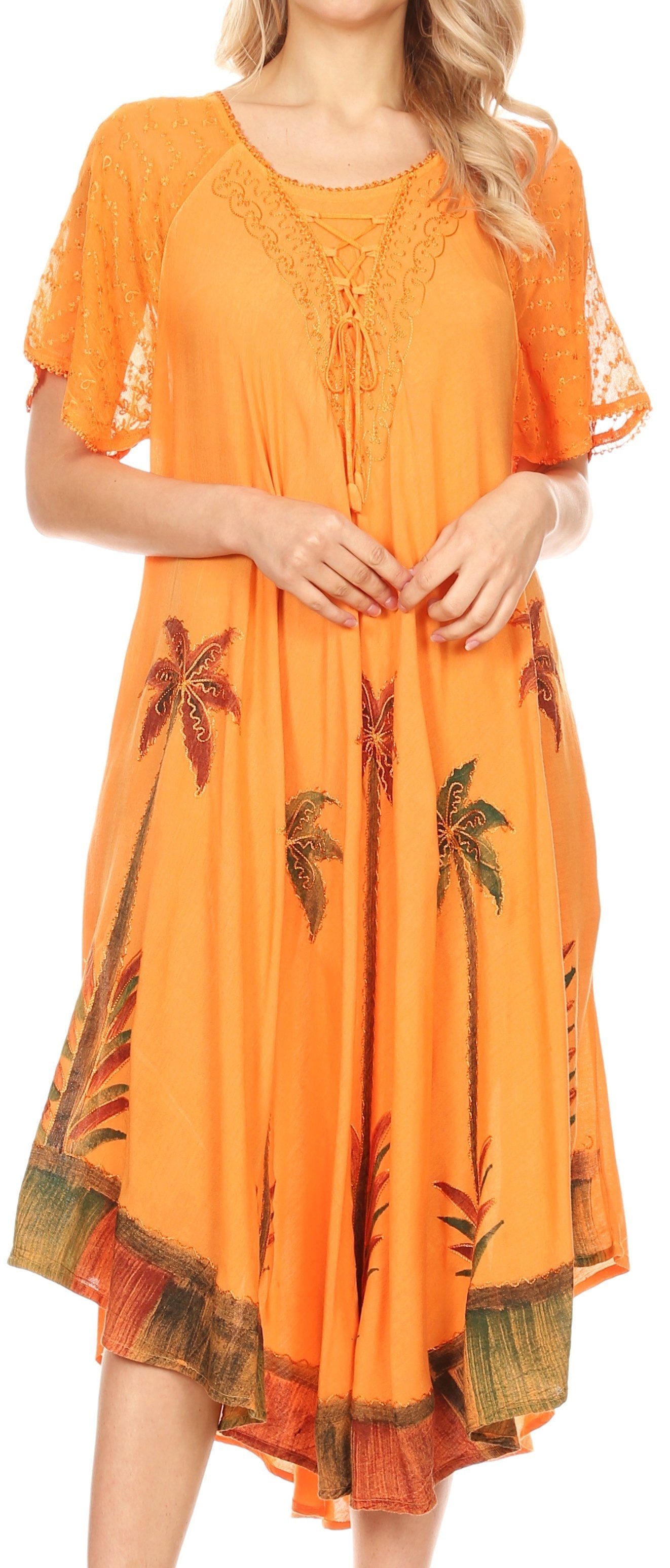 Orange dress with palm tree patterns worn by a model