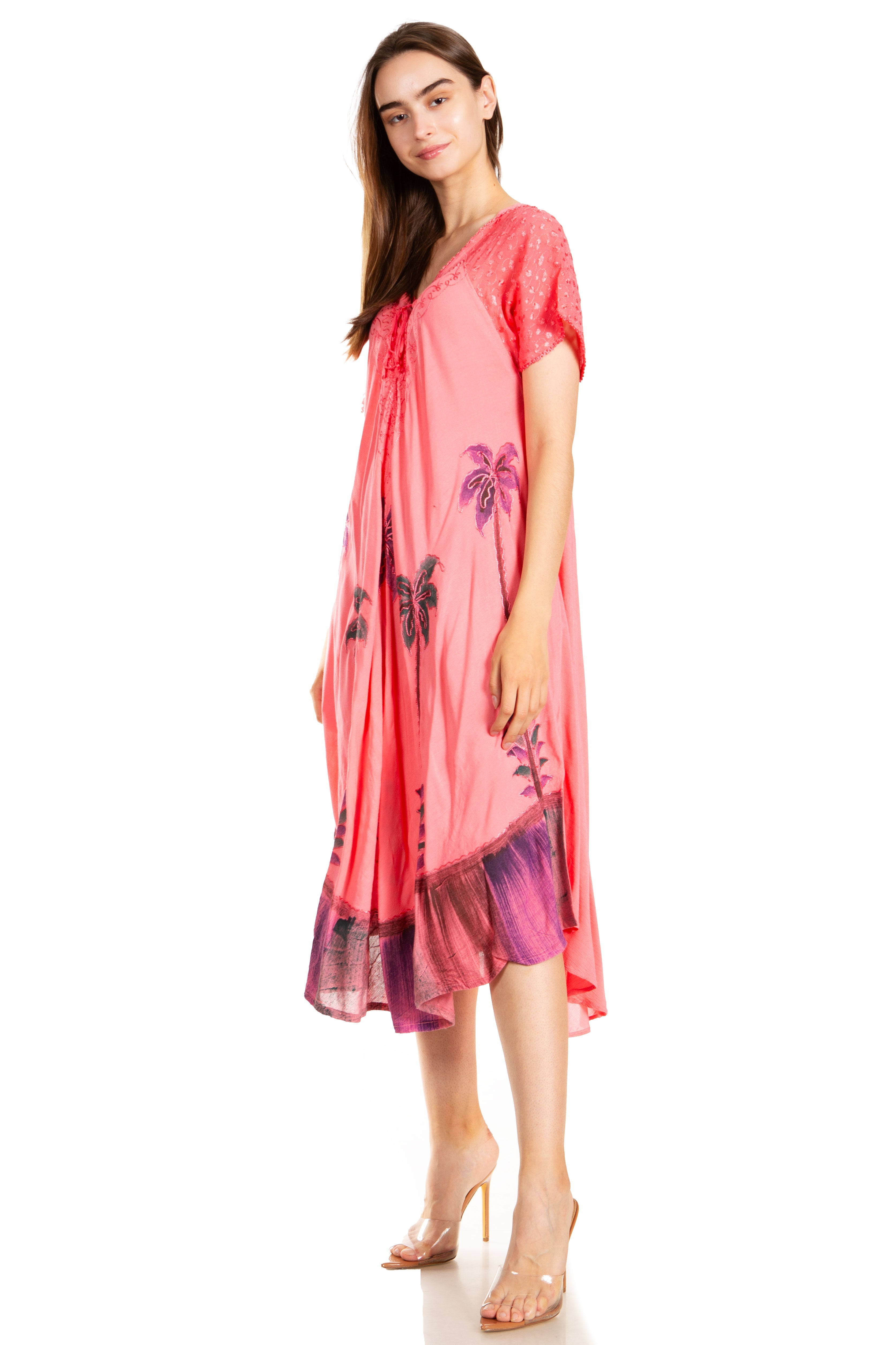 Woman wearing a pink dress with floral patterns on a white background