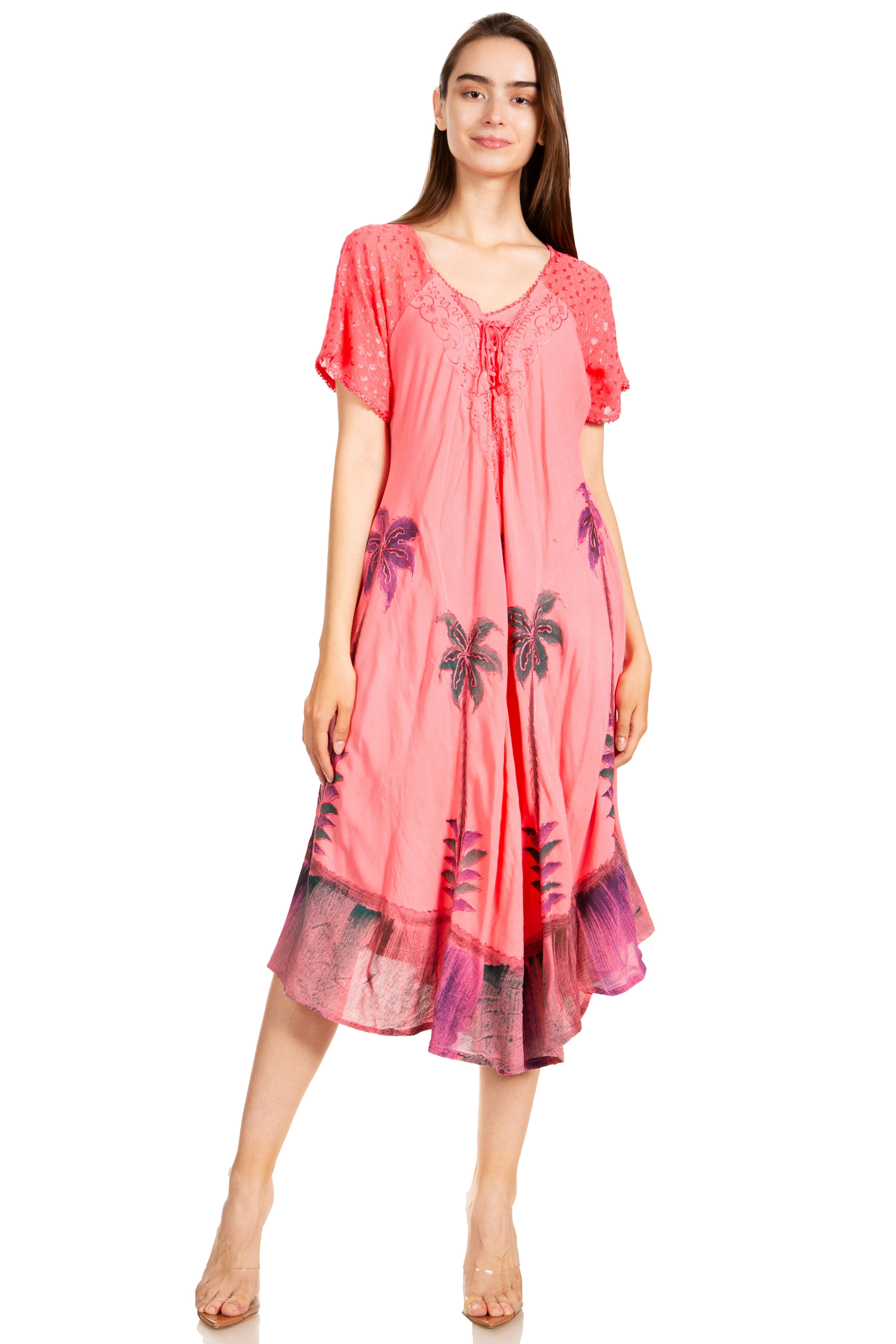 Woman wearing a pink dress with floral patterns on a white background