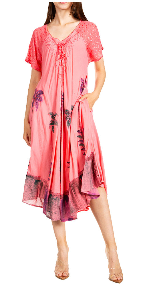 Woman wearing a pink dress with floral patterns on a white background