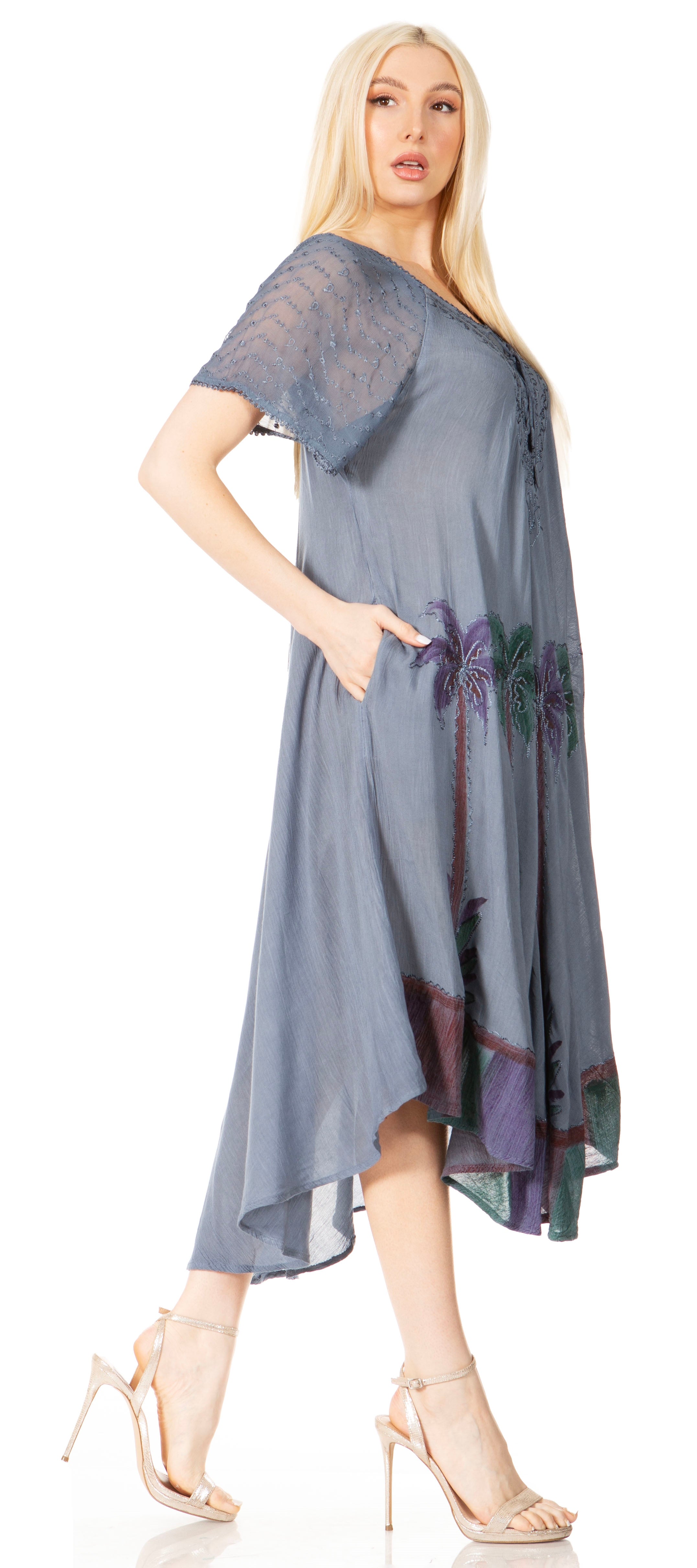 Woman wearing a blue dress with floral patterns on a white background