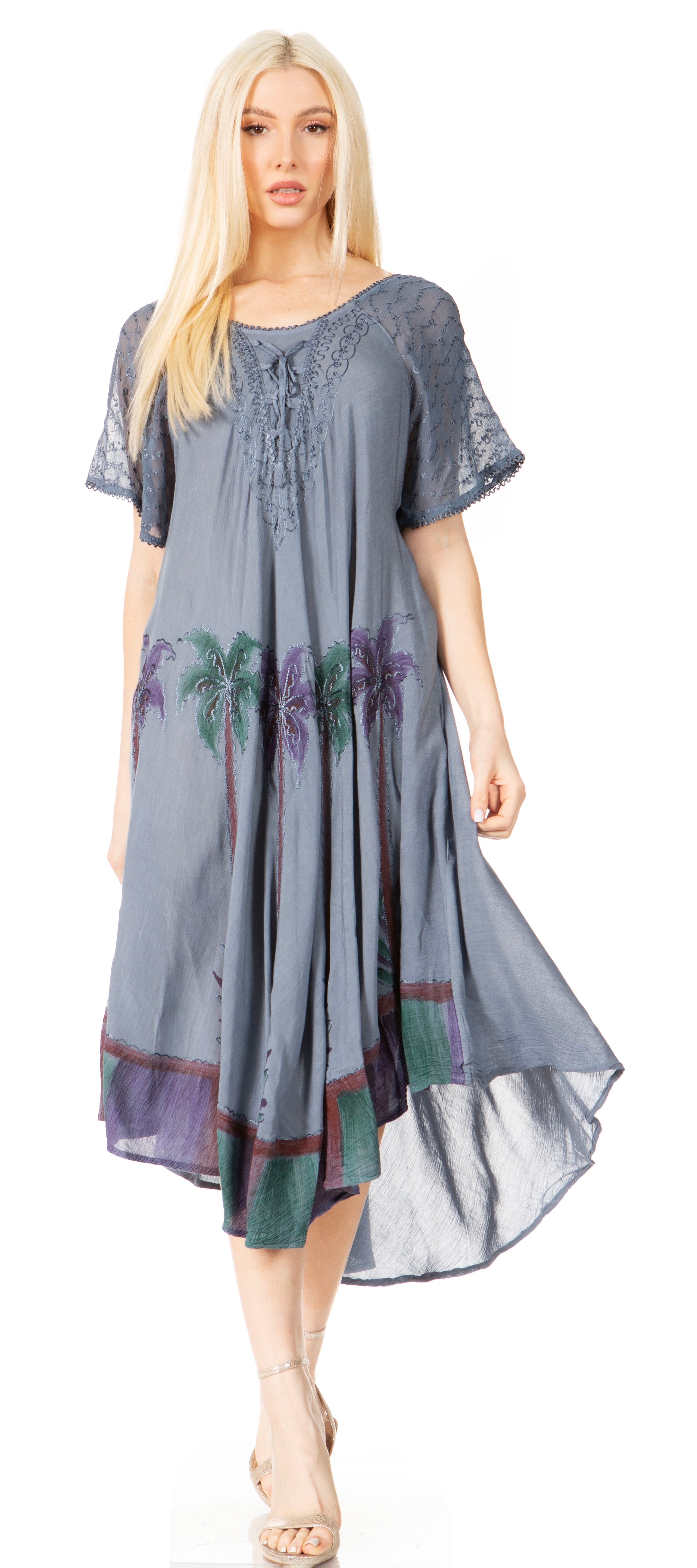 Woman wearing a gray dress with floral patterns on a white background