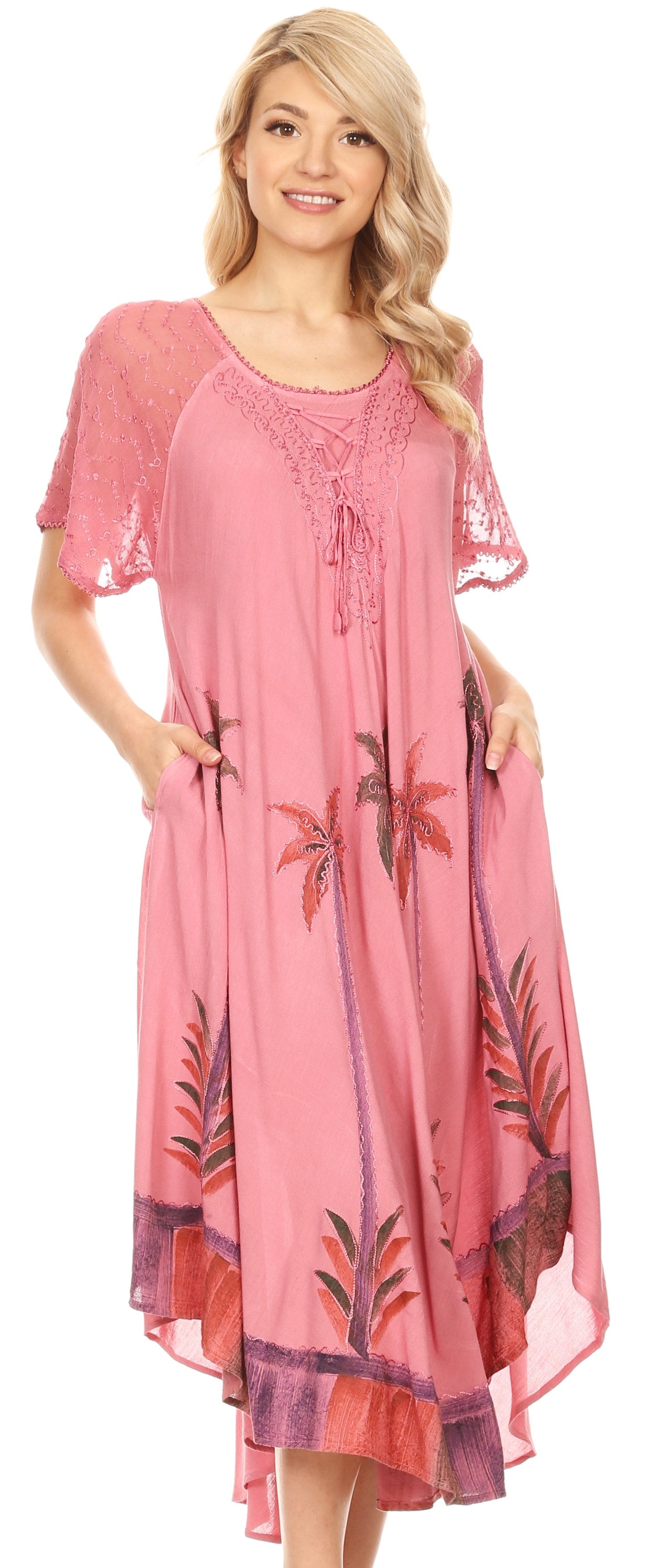 Woman wearing a pink dress with floral patterns on a white background