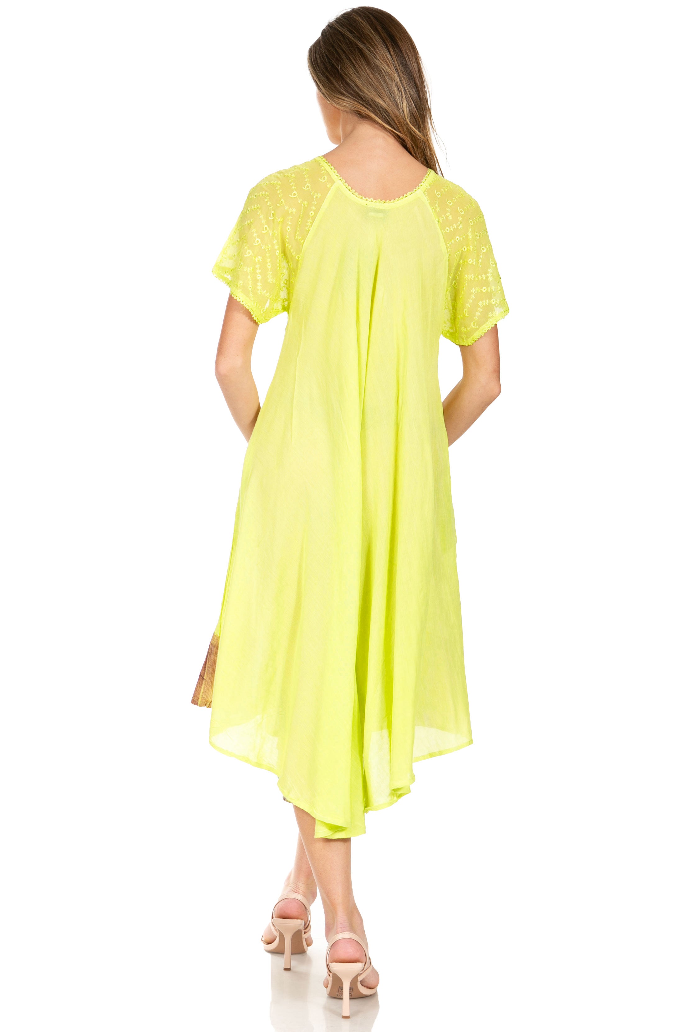 Woman wearing a bright yellow dress on a white background