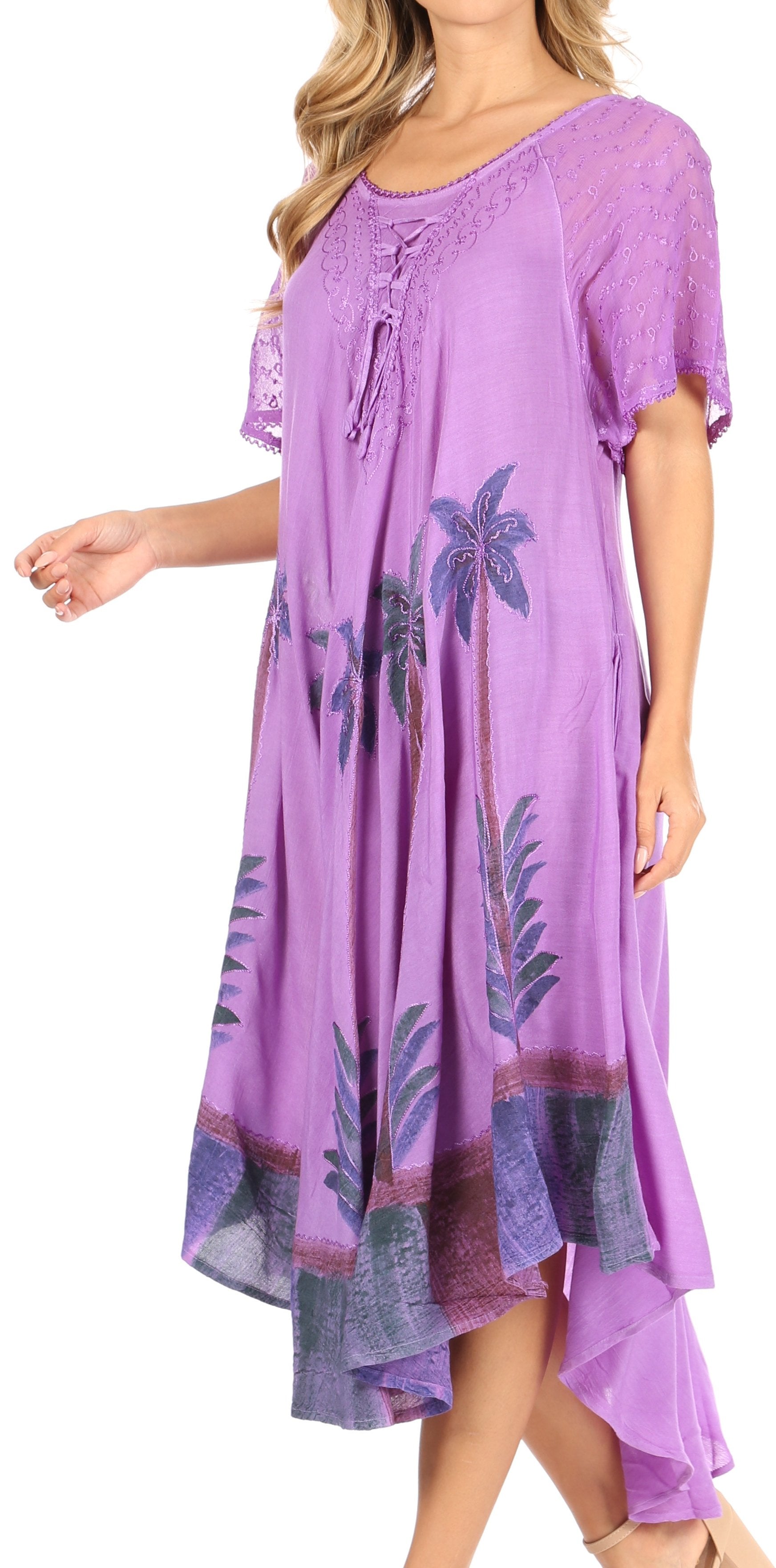 Purple dress with palm tree pattern worn by a model on a white background