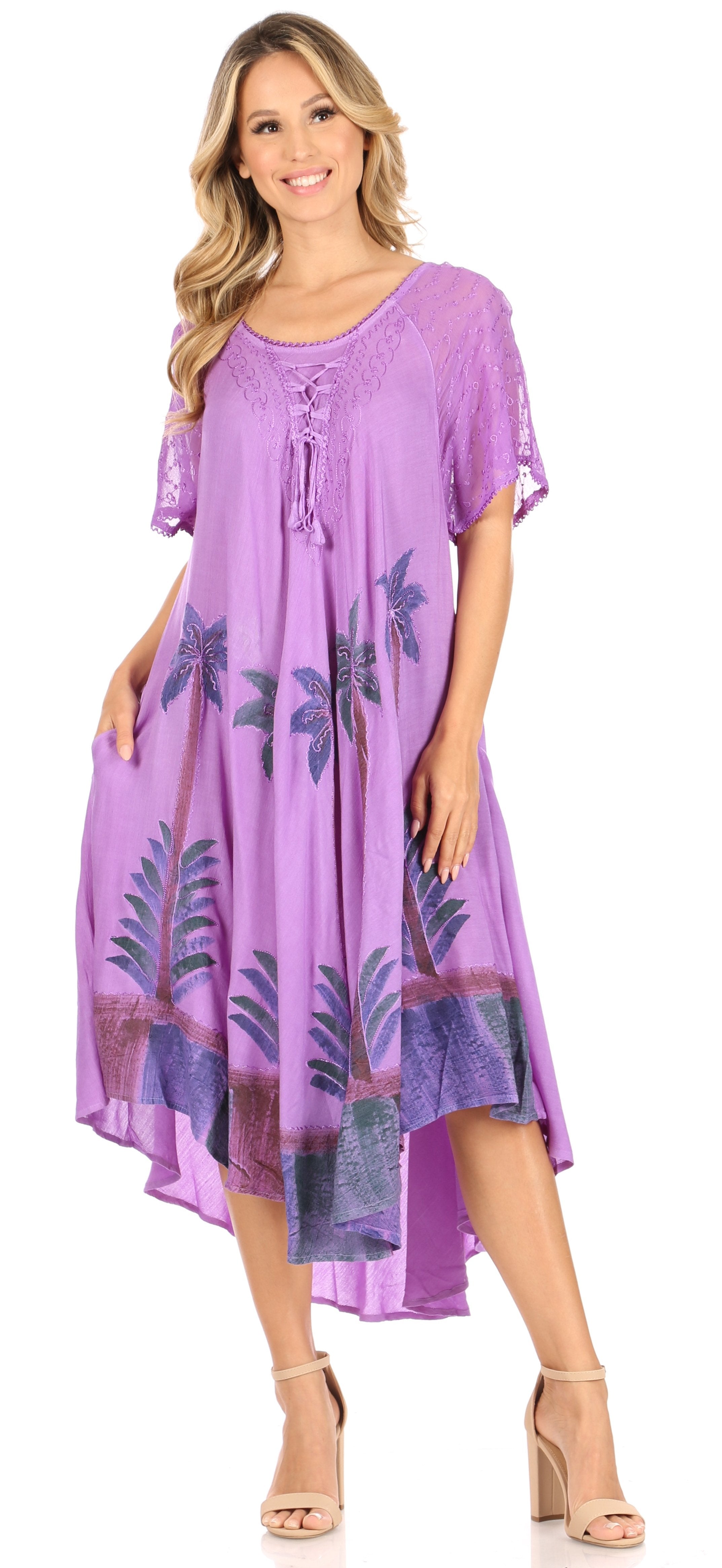 Woman wearing a purple dress with leaf patterns on a white background