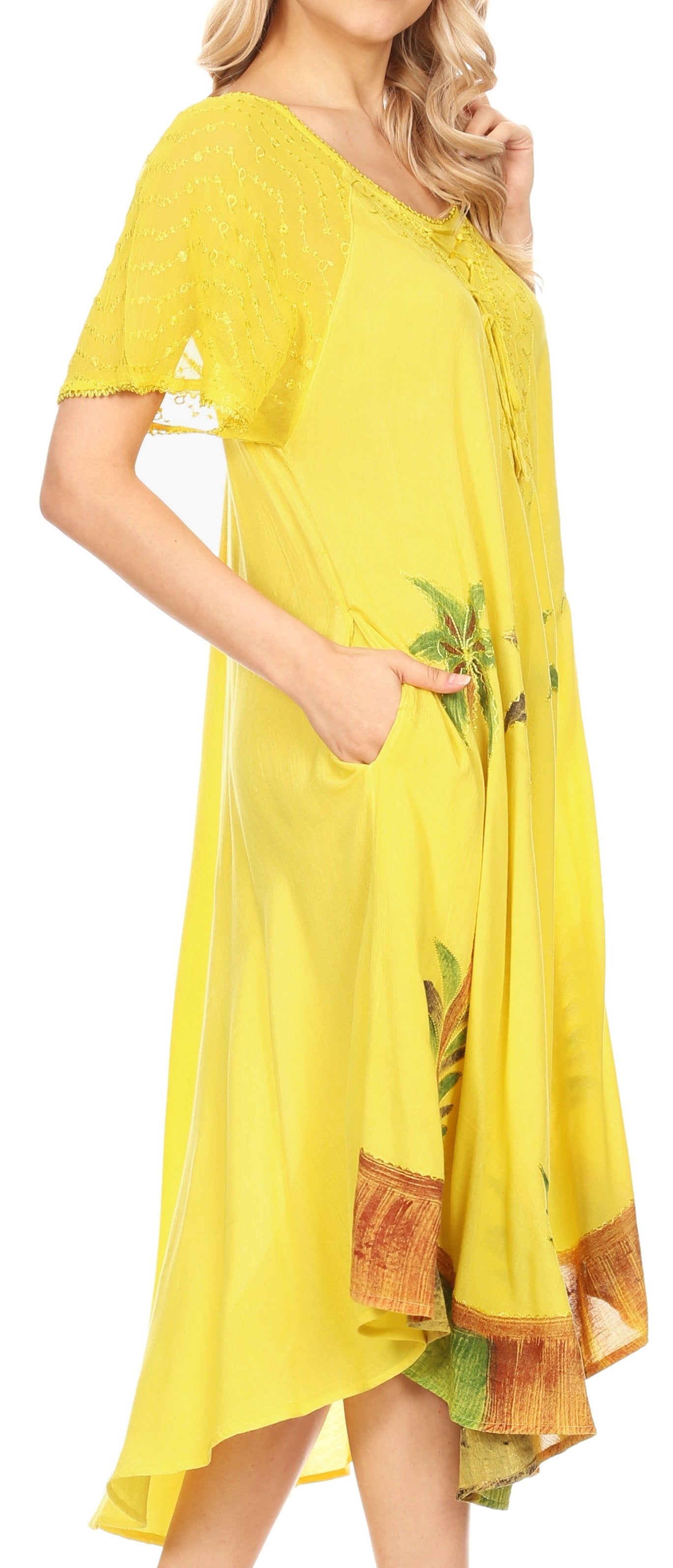 Woman wearing a yellow dress with floral patterns on a white background