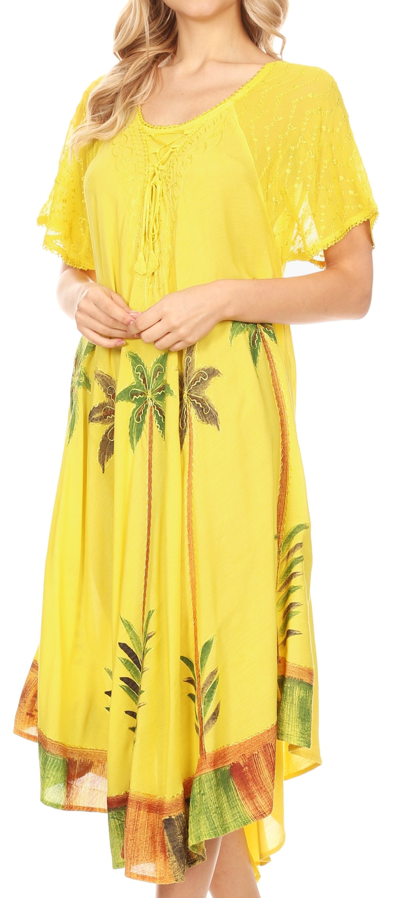 Yellow dress with tropical leaf patterns on a plain background