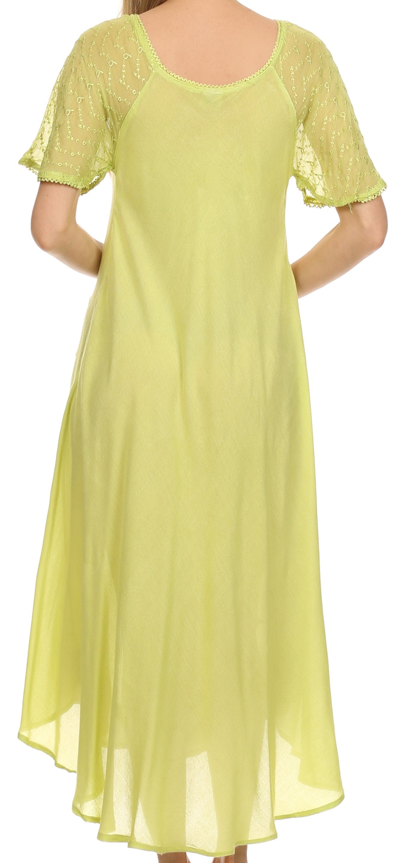 Woman wearing a light green dress with lace sleeves against a white background