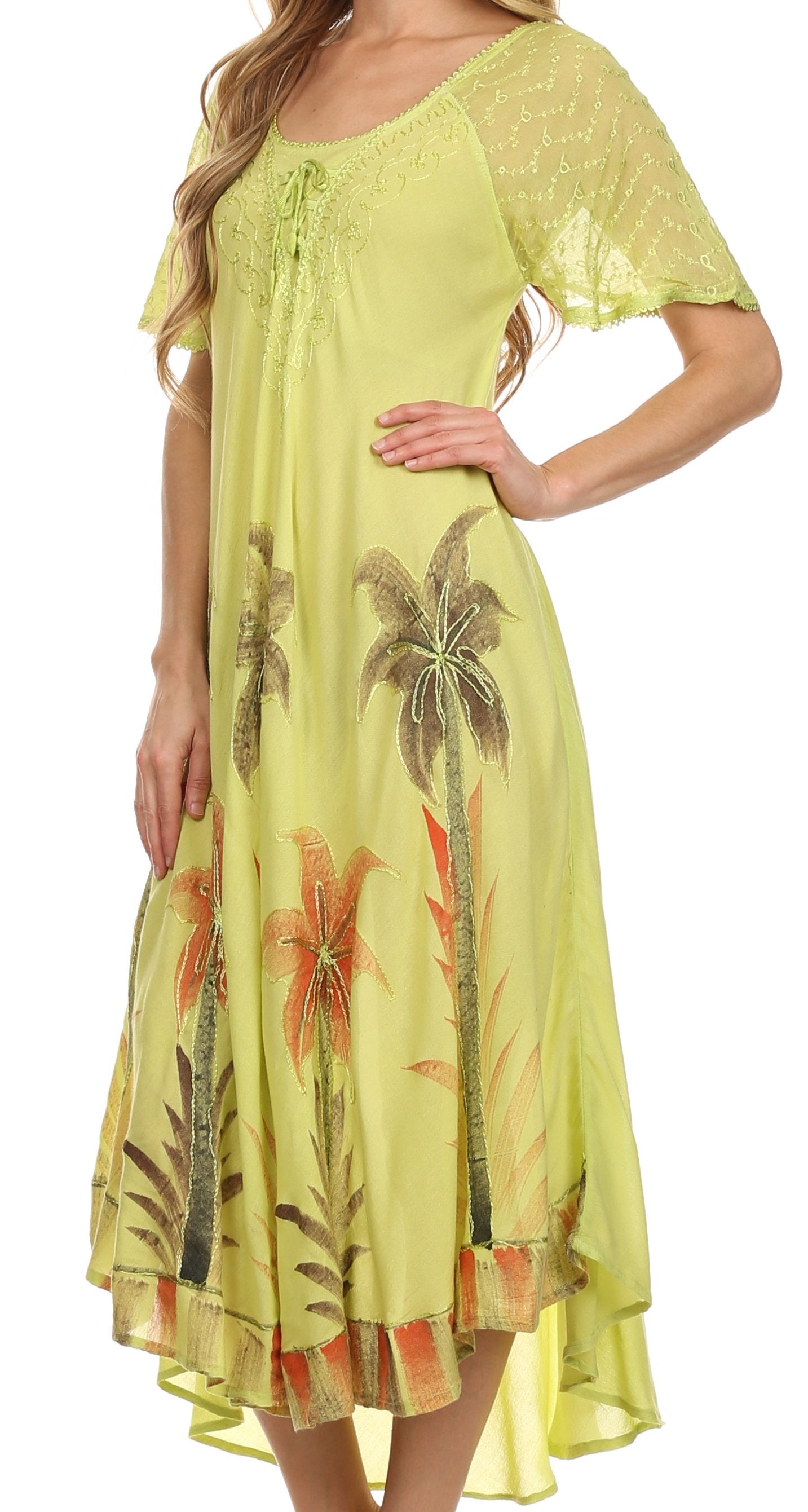 Woman wearing a yellow dress with palm tree patterns on a white background