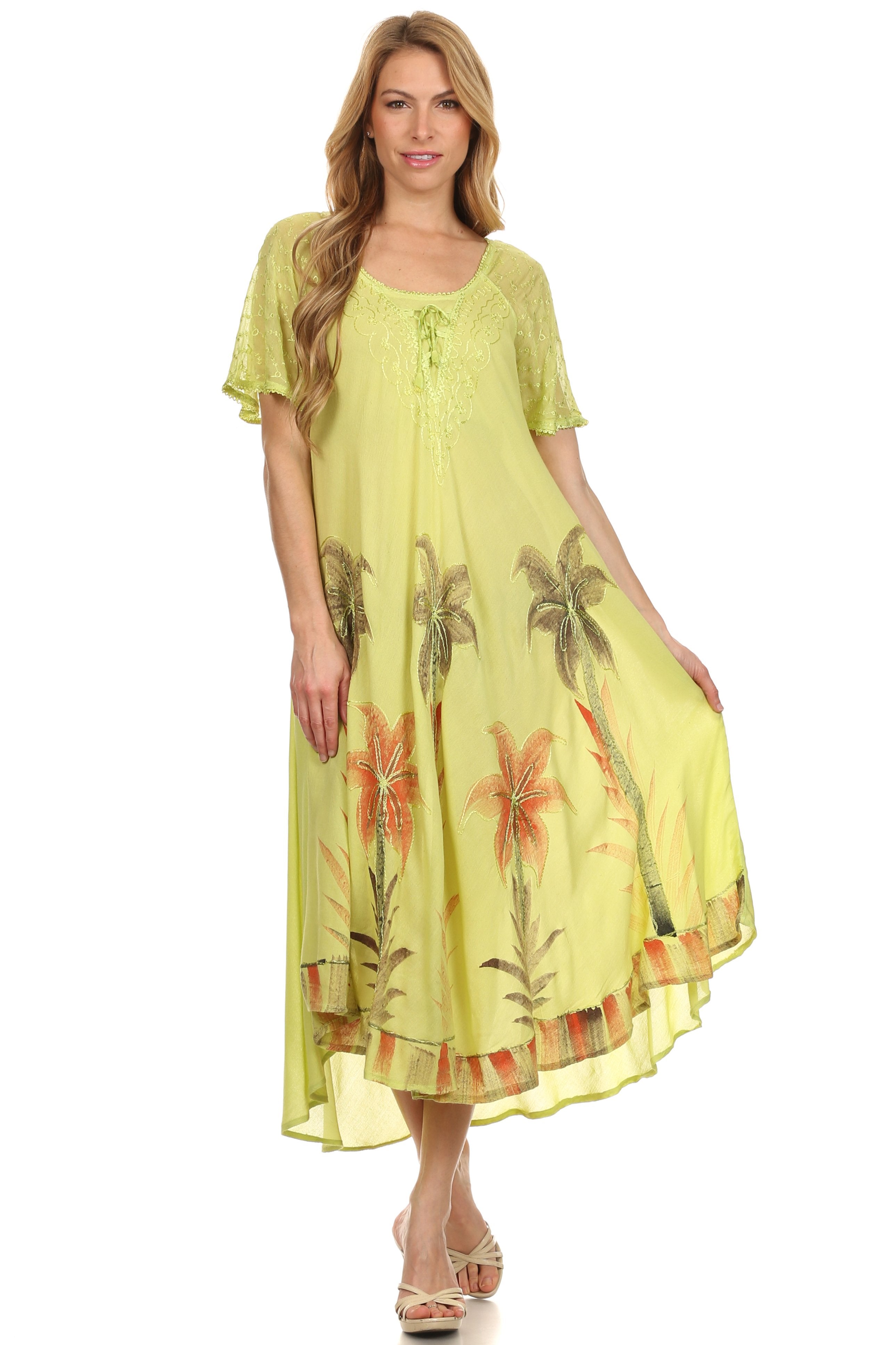 Woman wearing a yellow dress with floral patterns on a white background